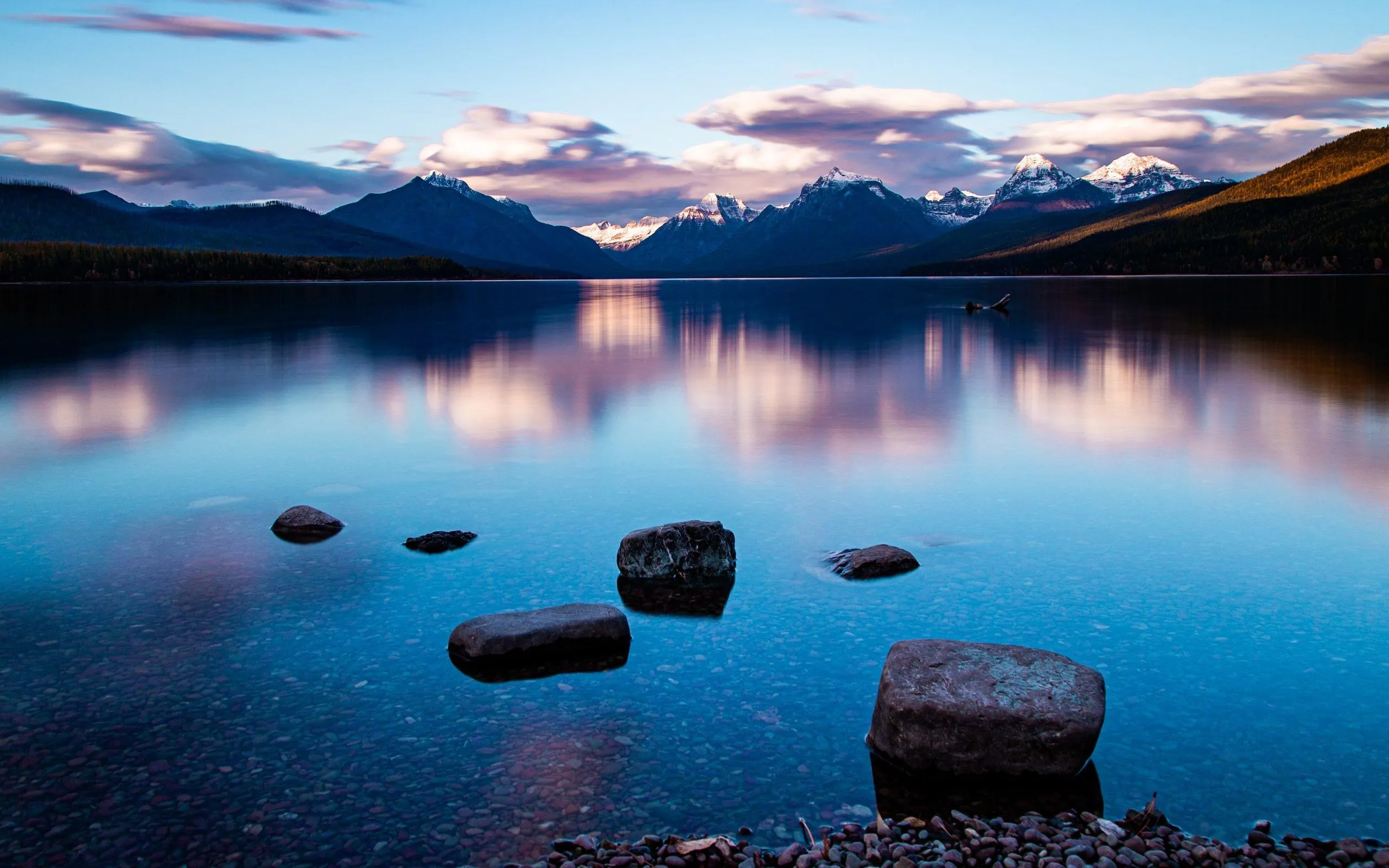 Clear Blue Ocean with Rocks and Pink Sunset Sky image