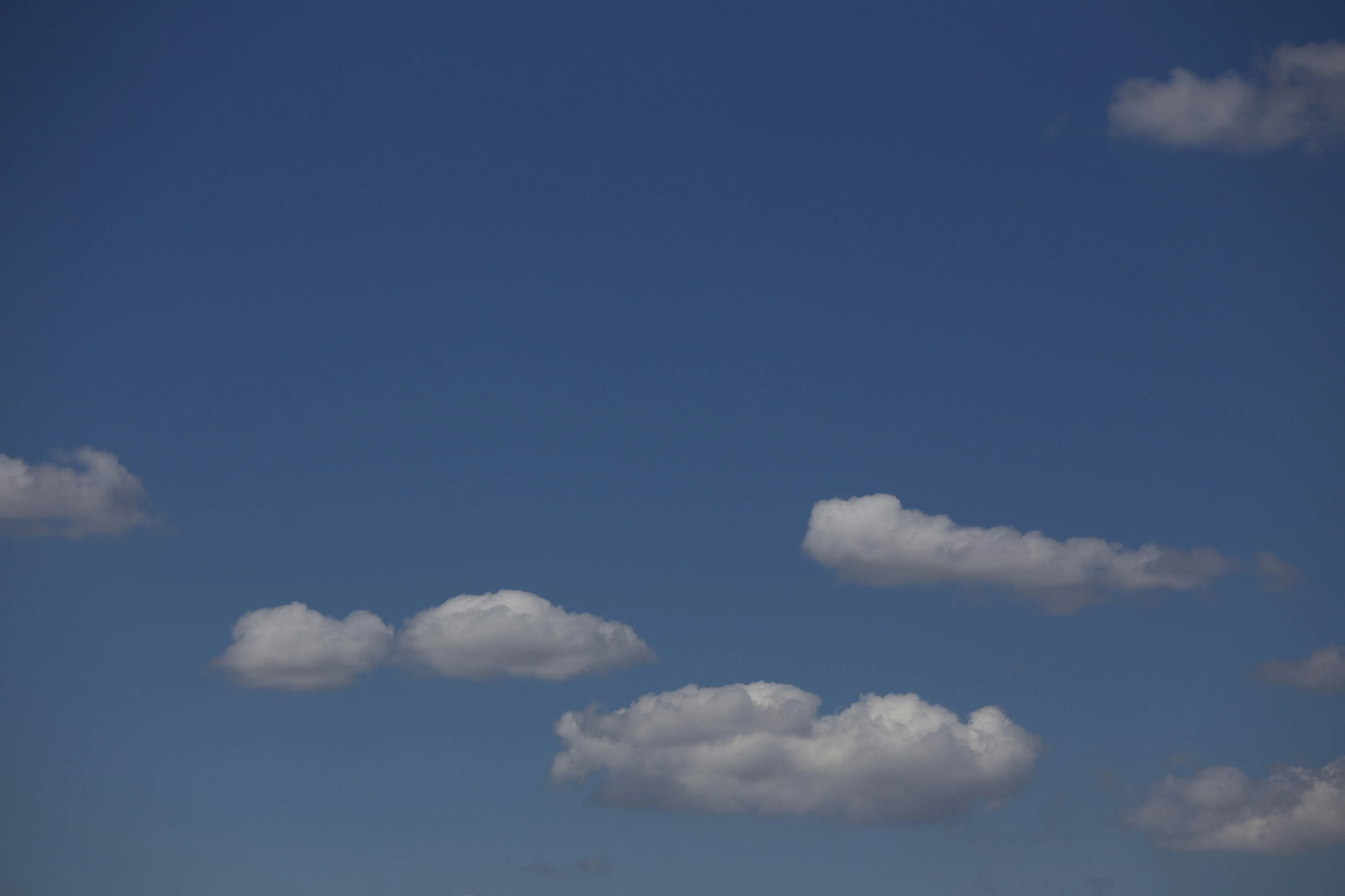 Clear Blue Sky with Few Scattered Cotton Like Clouds