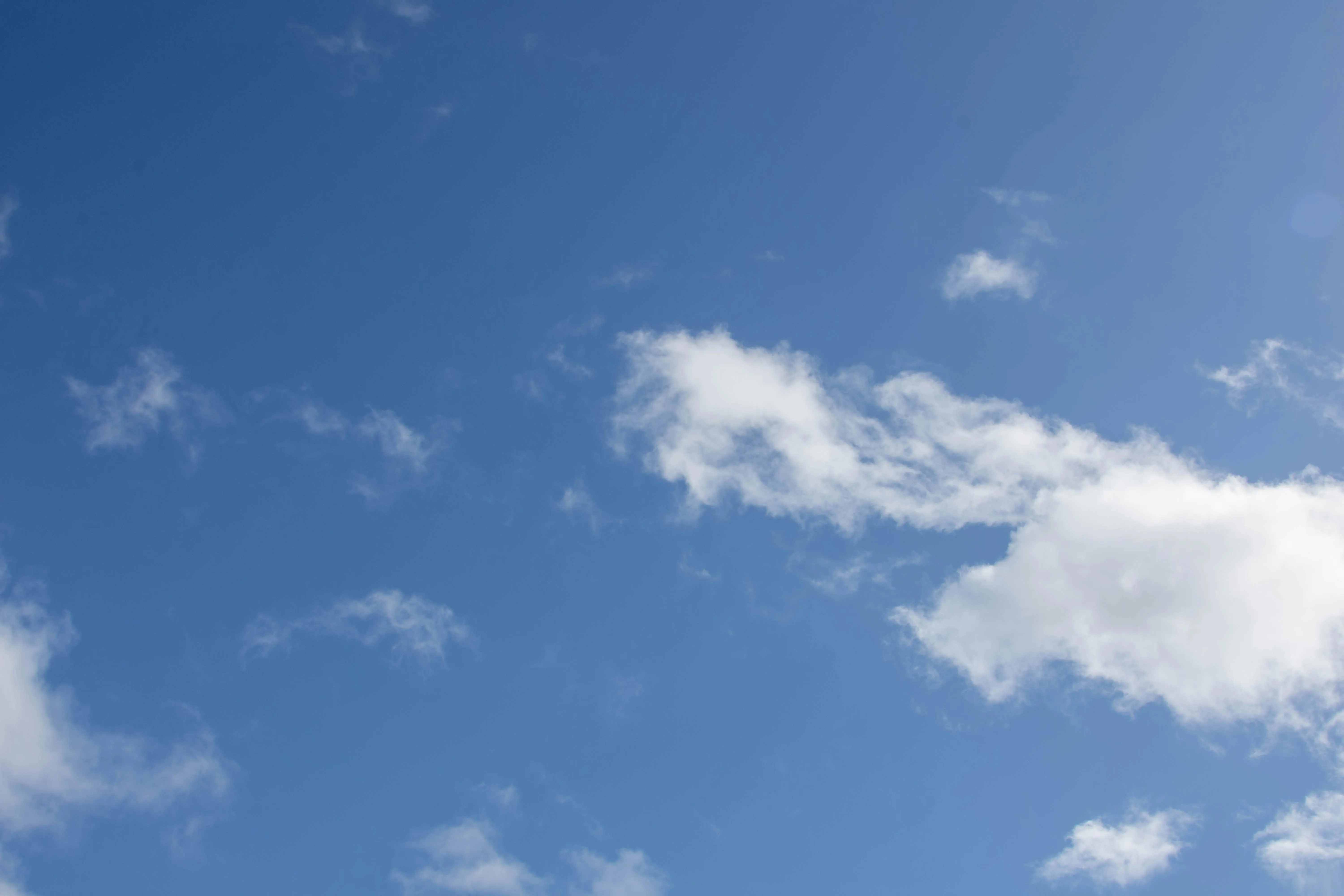 Clear Blue Sky with Few White Clouds on Bright Day