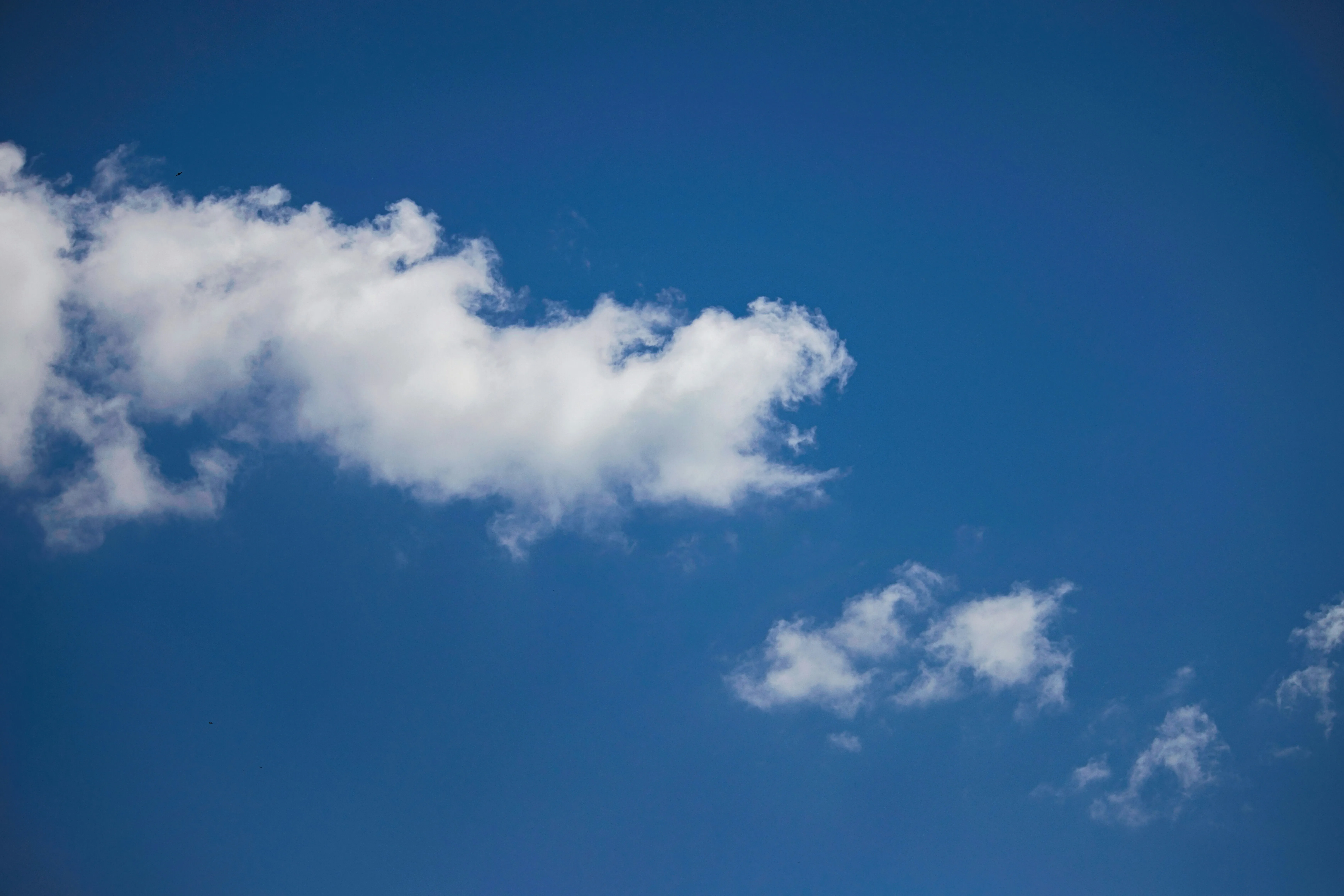 Clear Blue Sky with Soft White Clouds in Peaceful Atmosphere