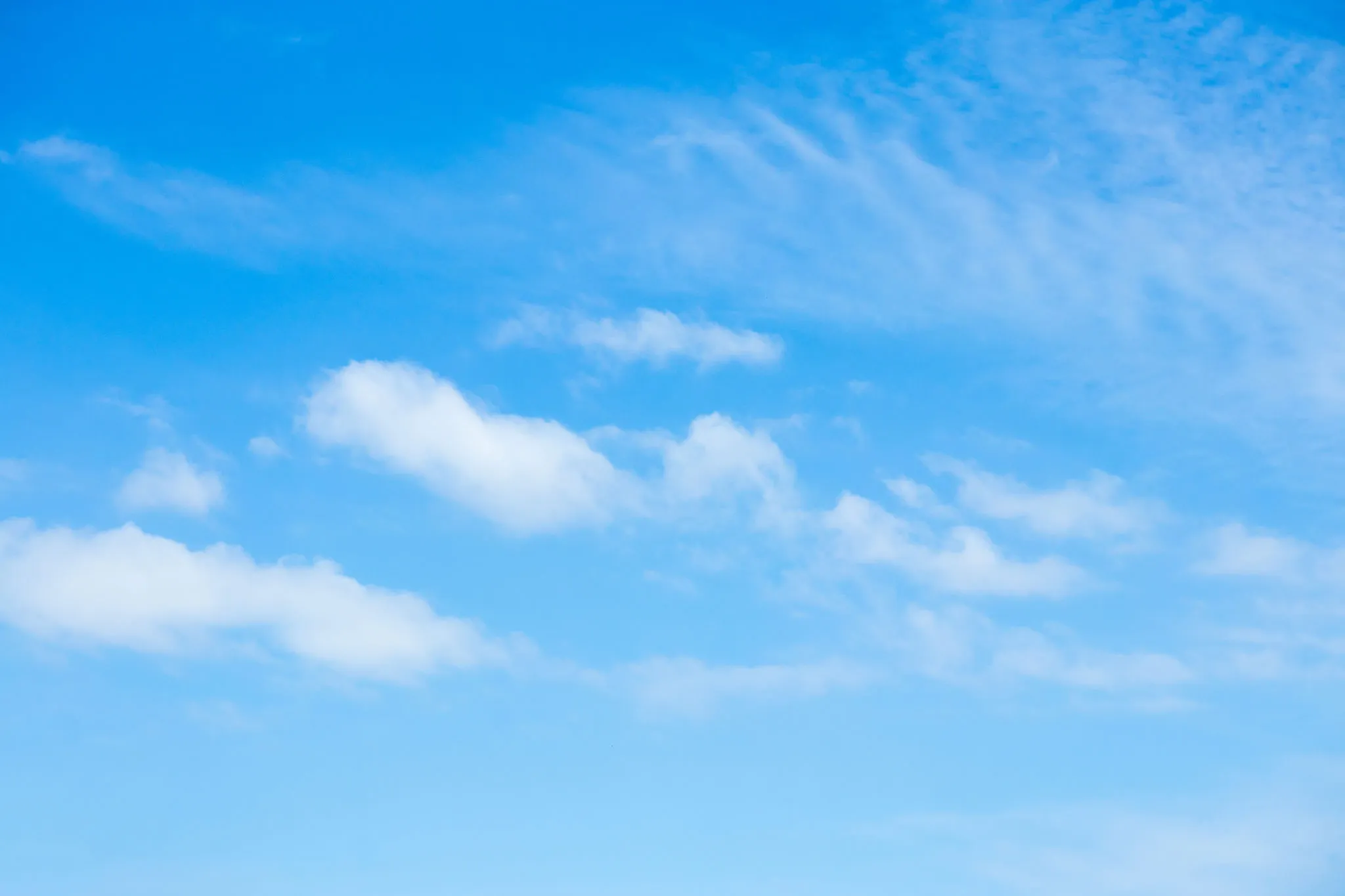 Clear Blue Sky with Sparse White Clouds HD Wallpaper
