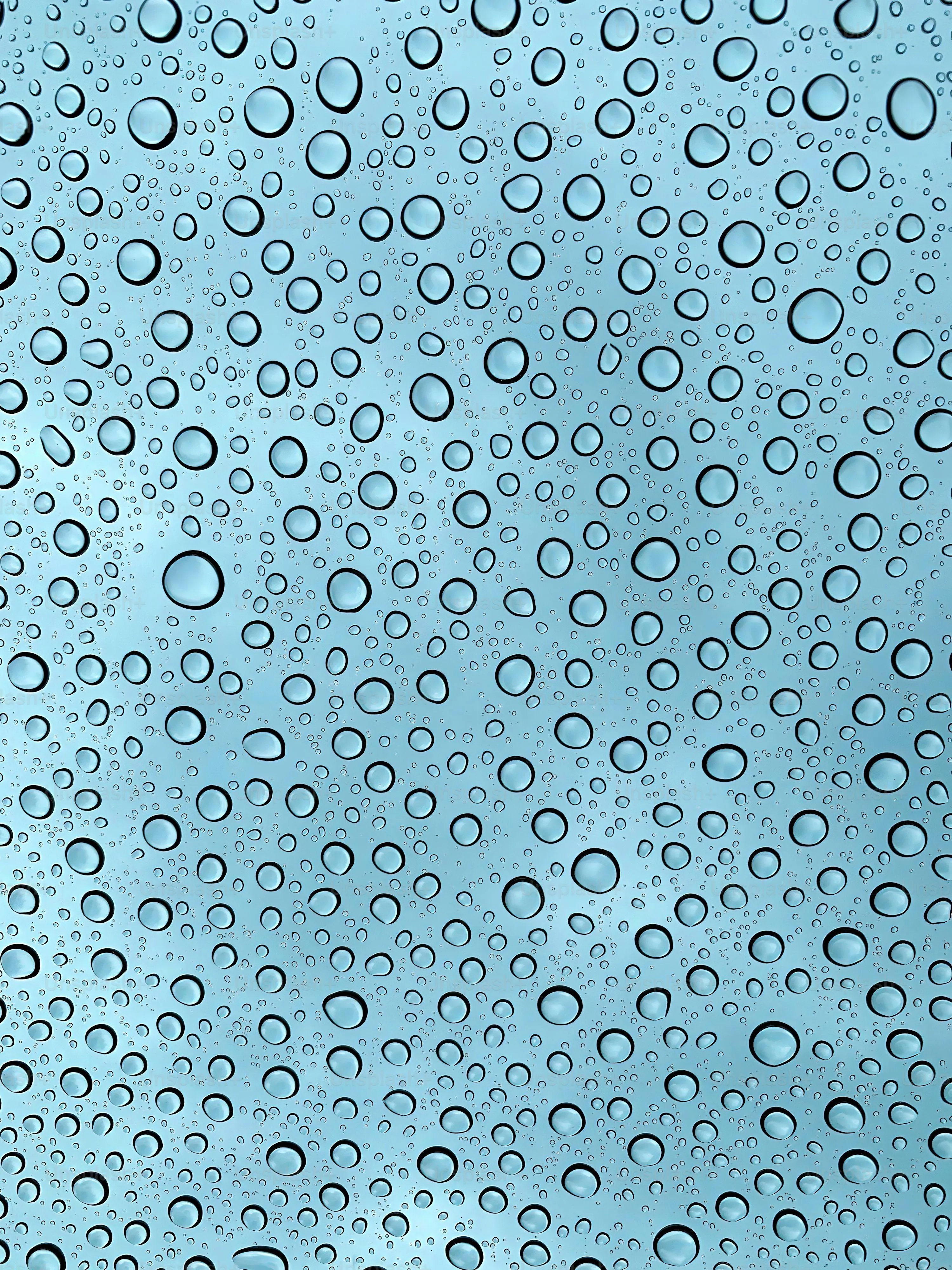 Clear Droplets on Glass Representing Heavy Rainfall