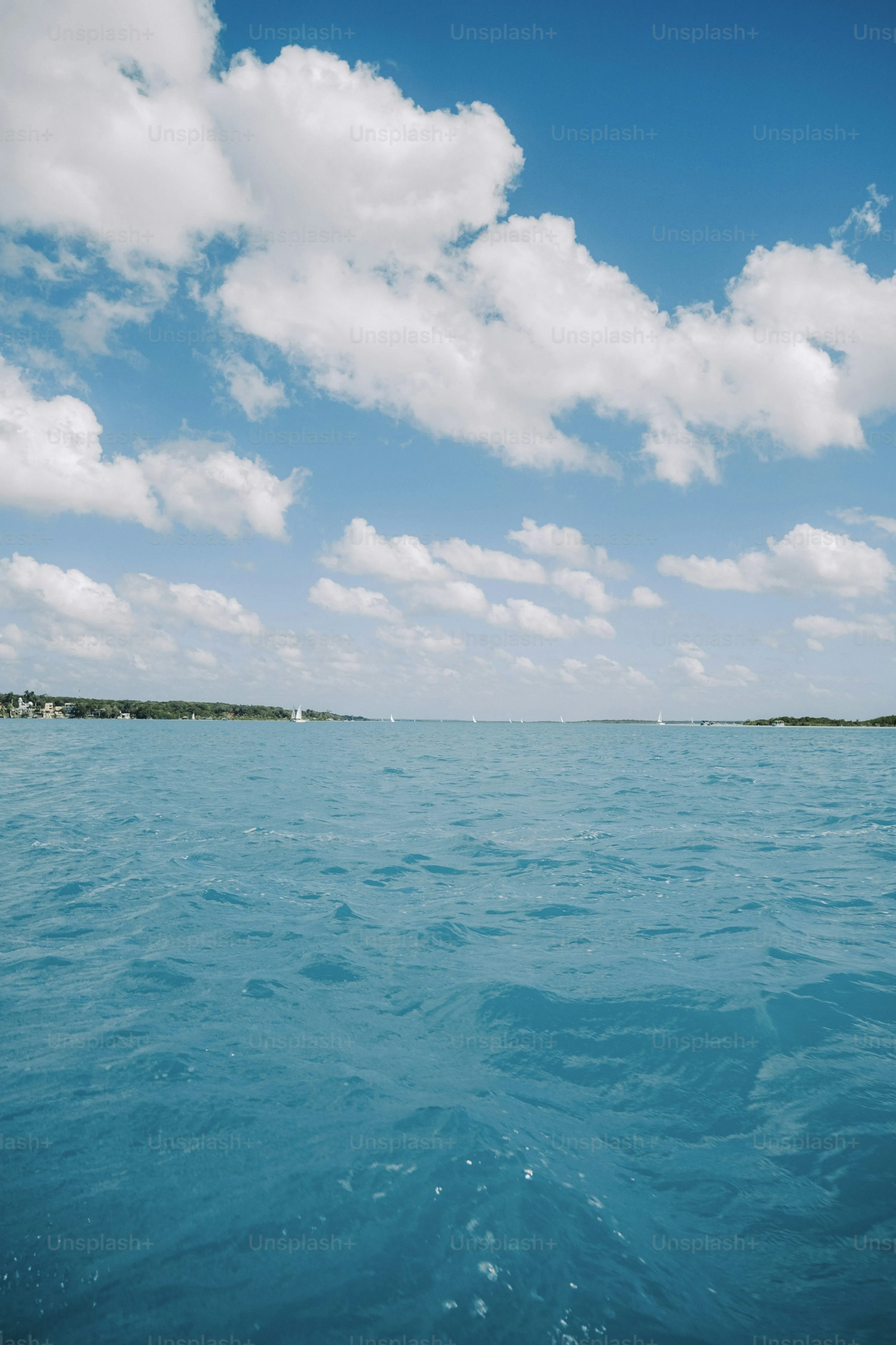 Clear Turquoise Ocean Water with Gentle Waves Under Sky