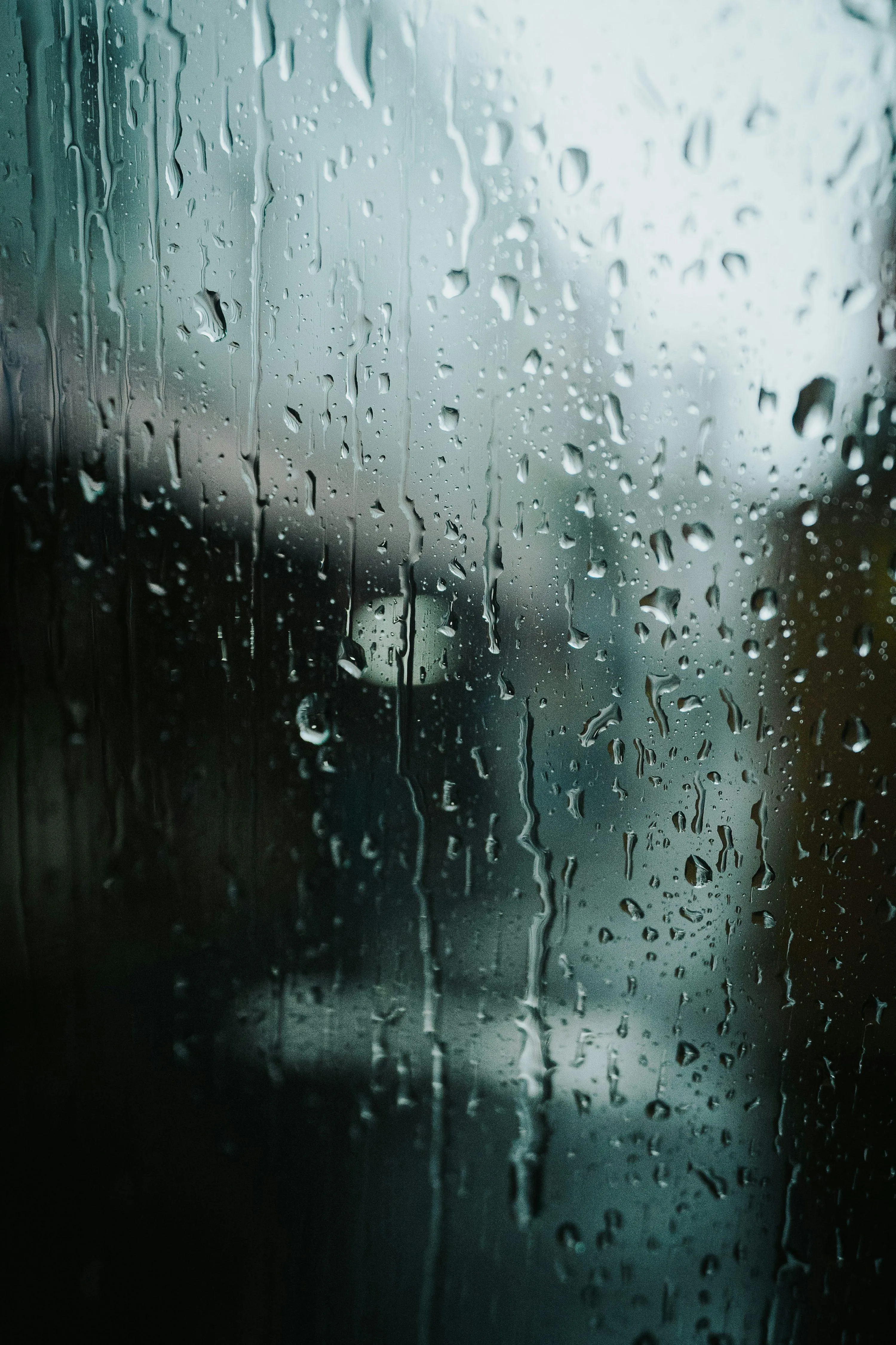 Clear View of Rain Falling on Glass Window Pane Wallpaper