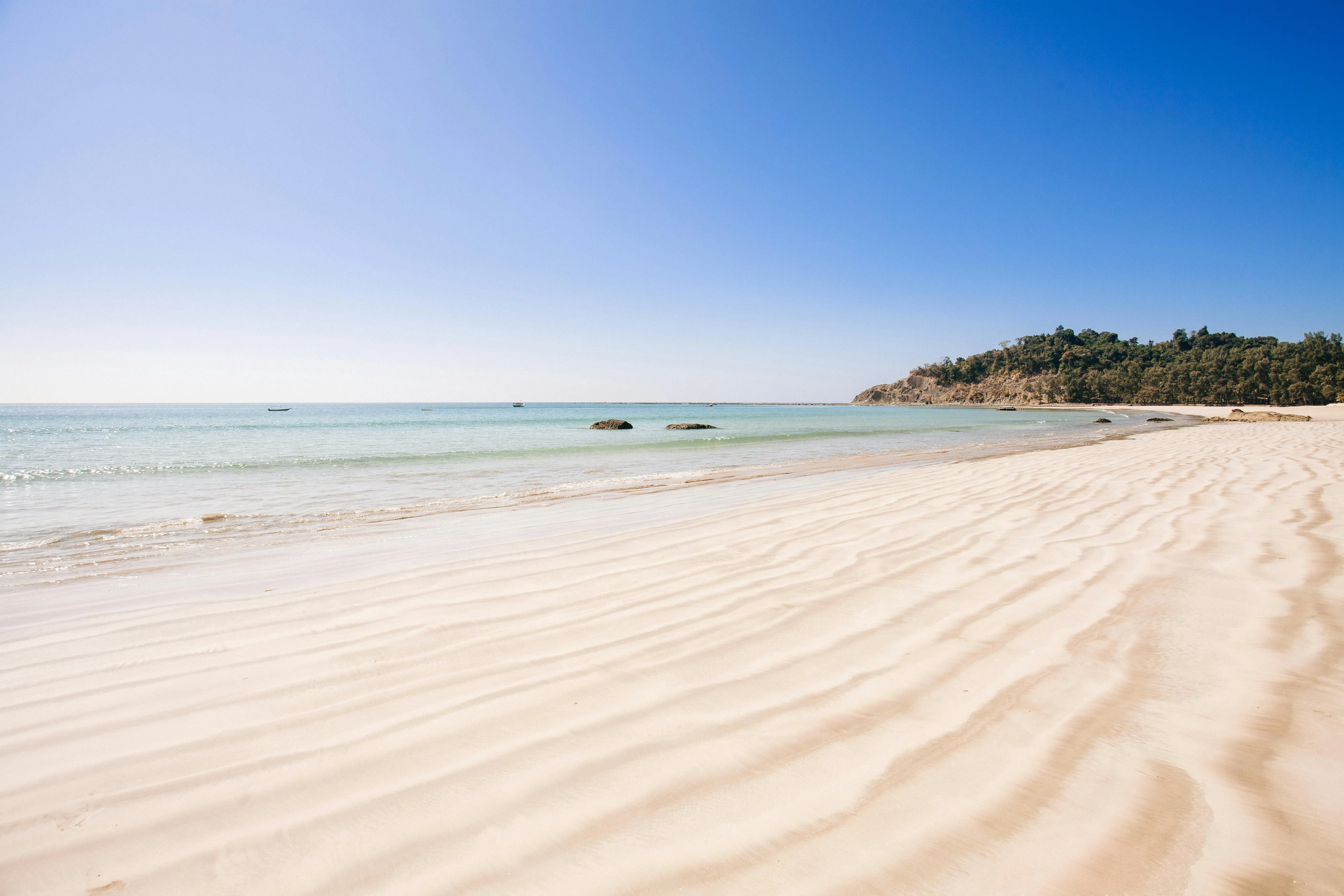 Clear White Sand Beach with Turquoise Ocean on Sunny Day