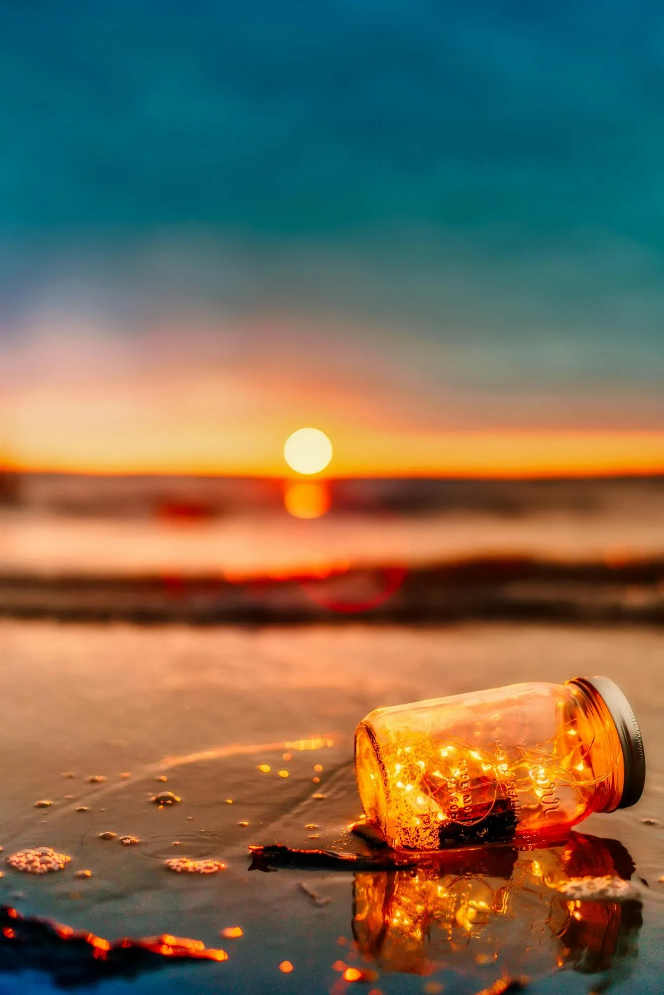 Close Up of a Bottle on the Beach During Sunset Wallpaper