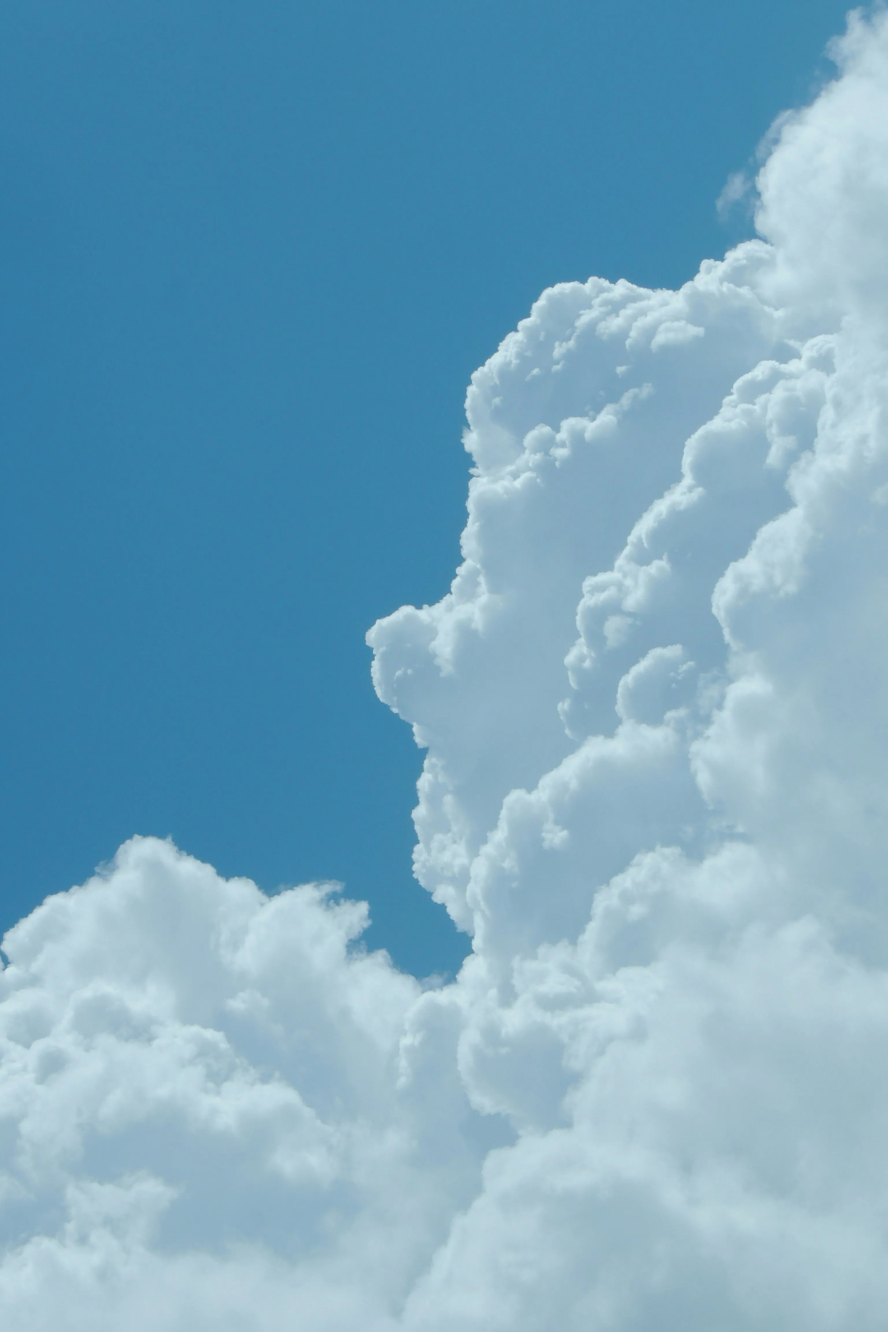 Close Up of Tall Cumulus Clouds in Bright Blue Sky Image