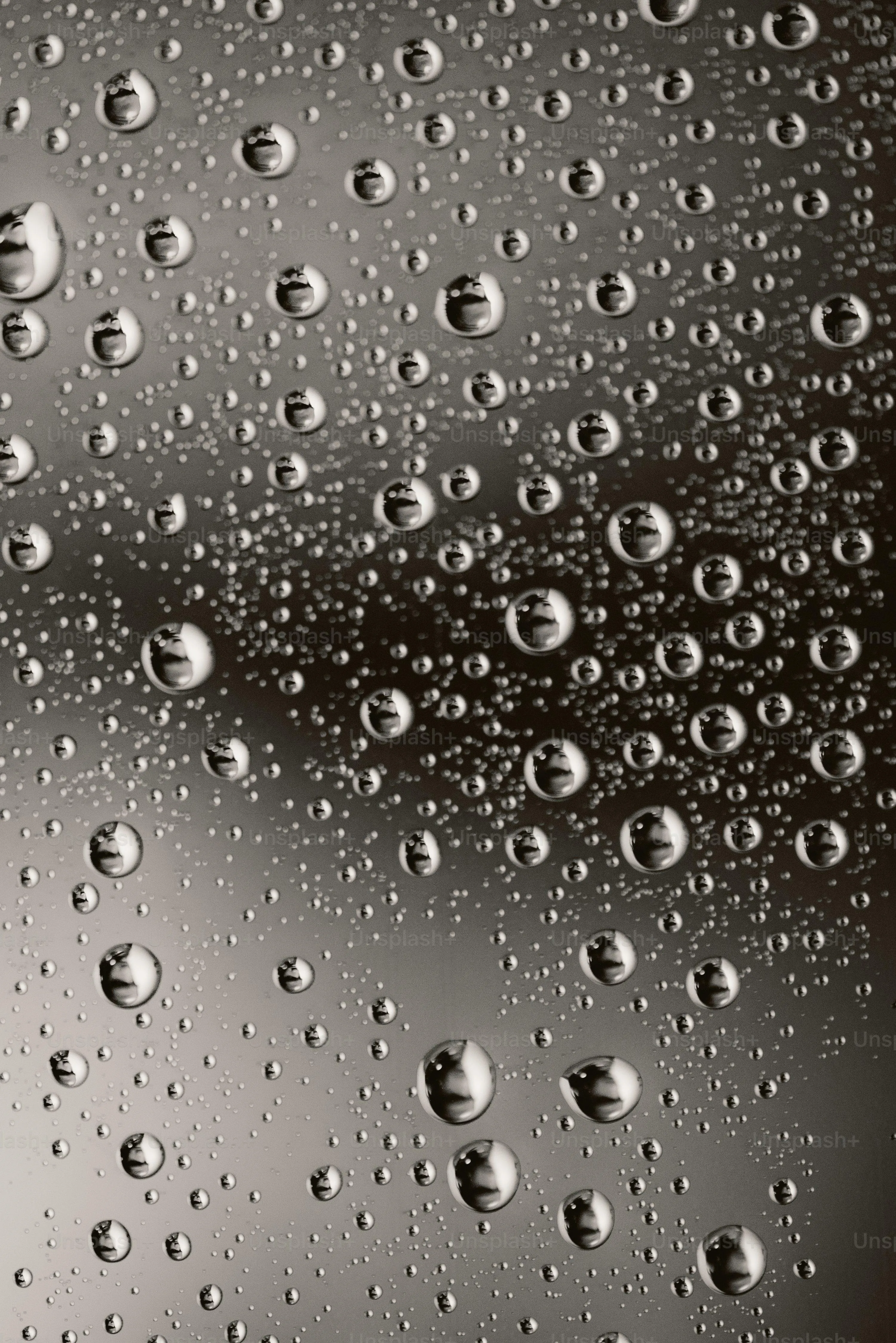 Closeup Raindrops on Glass with Blurred Night Lights