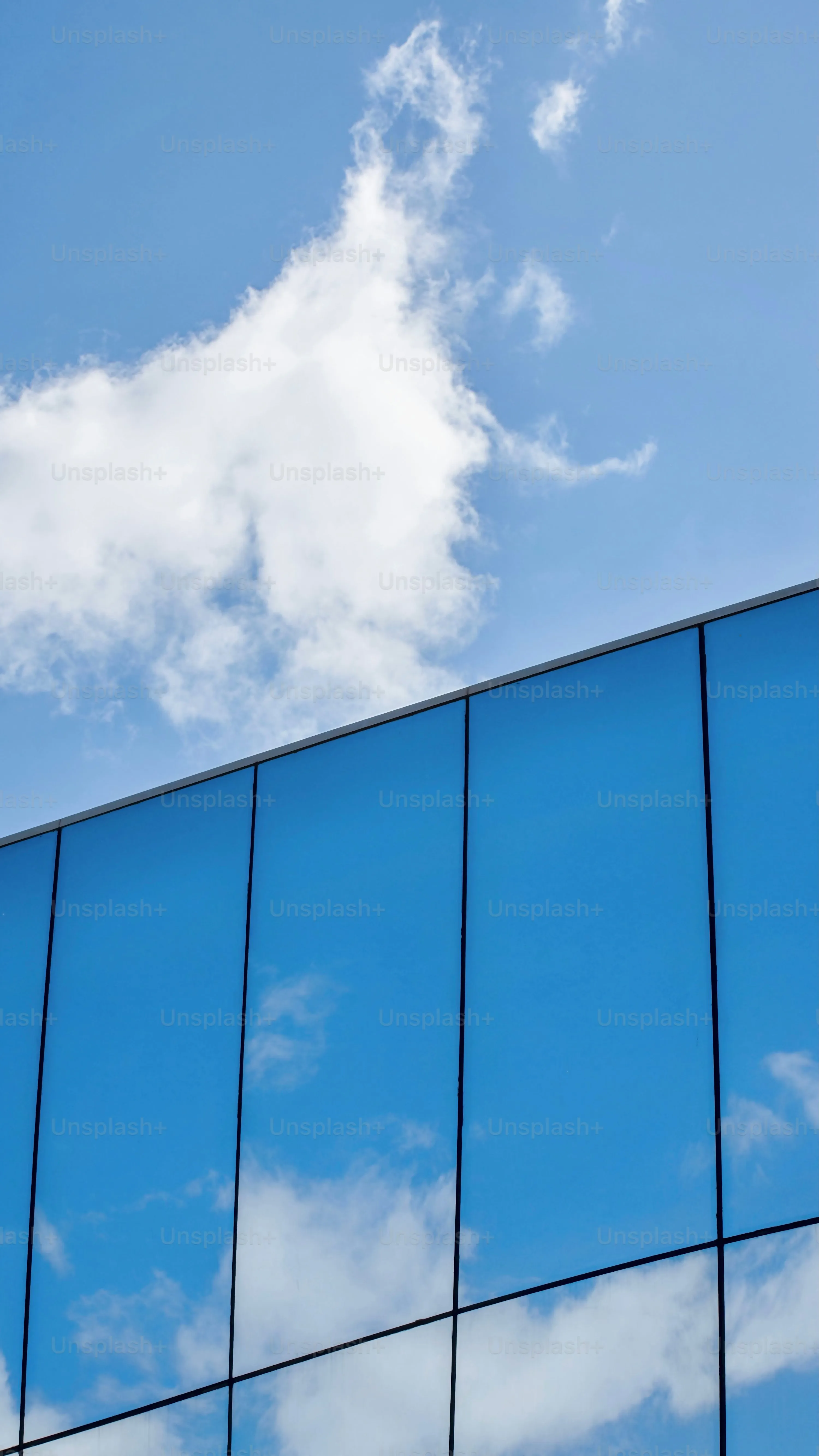 Cloud Reflected in Tall Glass Building Windows Image
