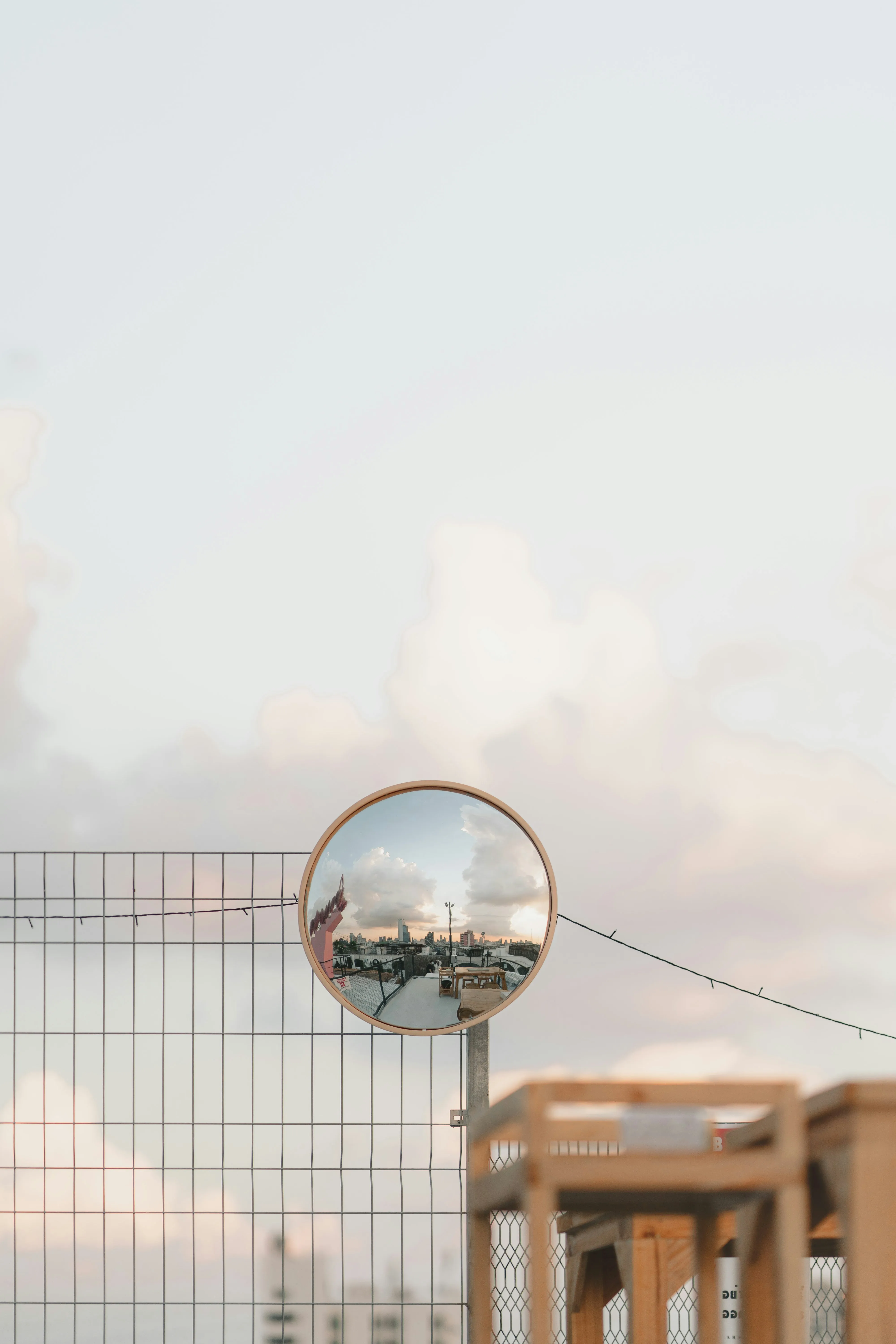 Cloudy Sky Reflecting in a Mirrored Sphere on Table