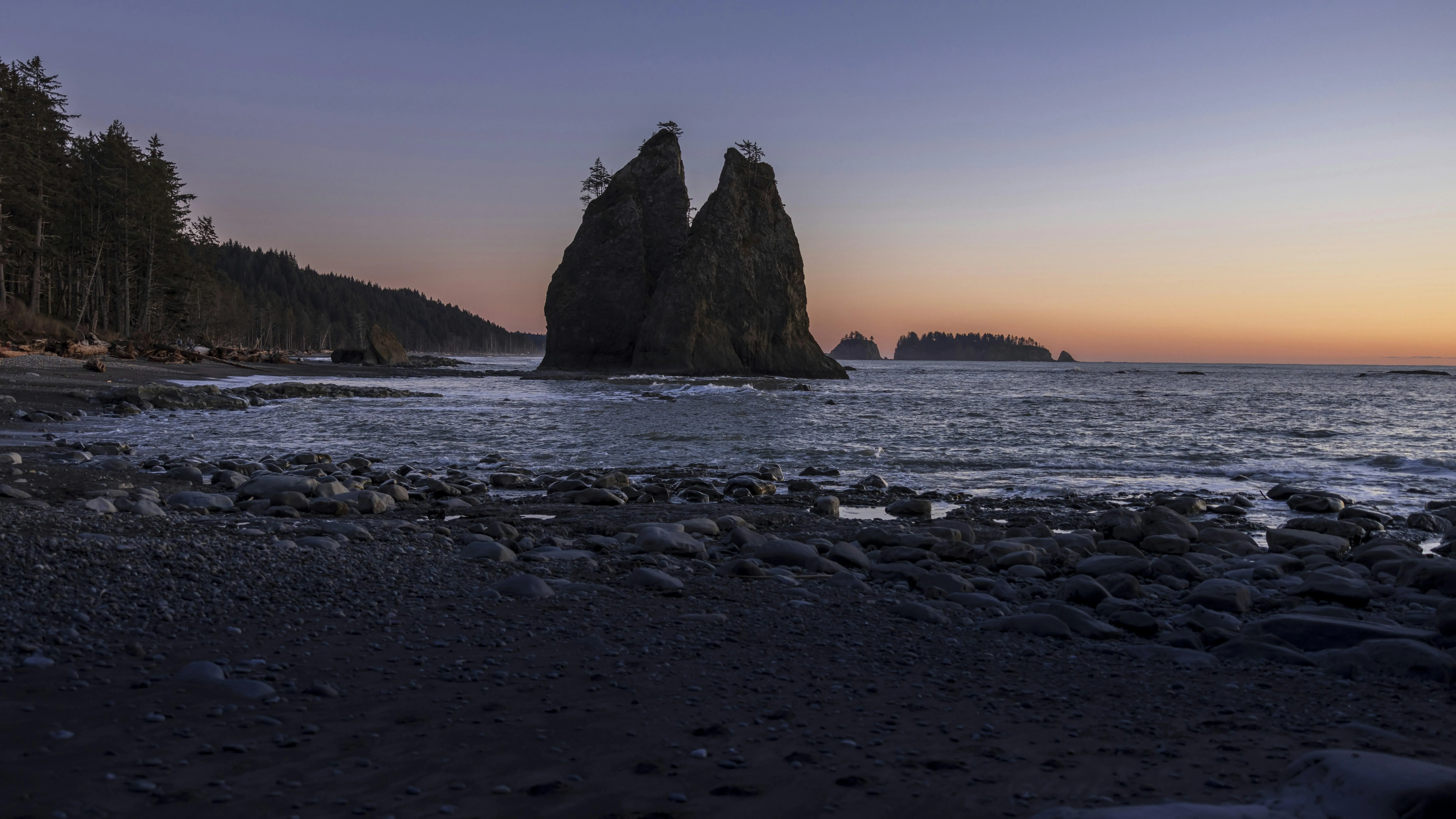 Coastal Rock Formations at Sunset with Calm Sea Wallpaper