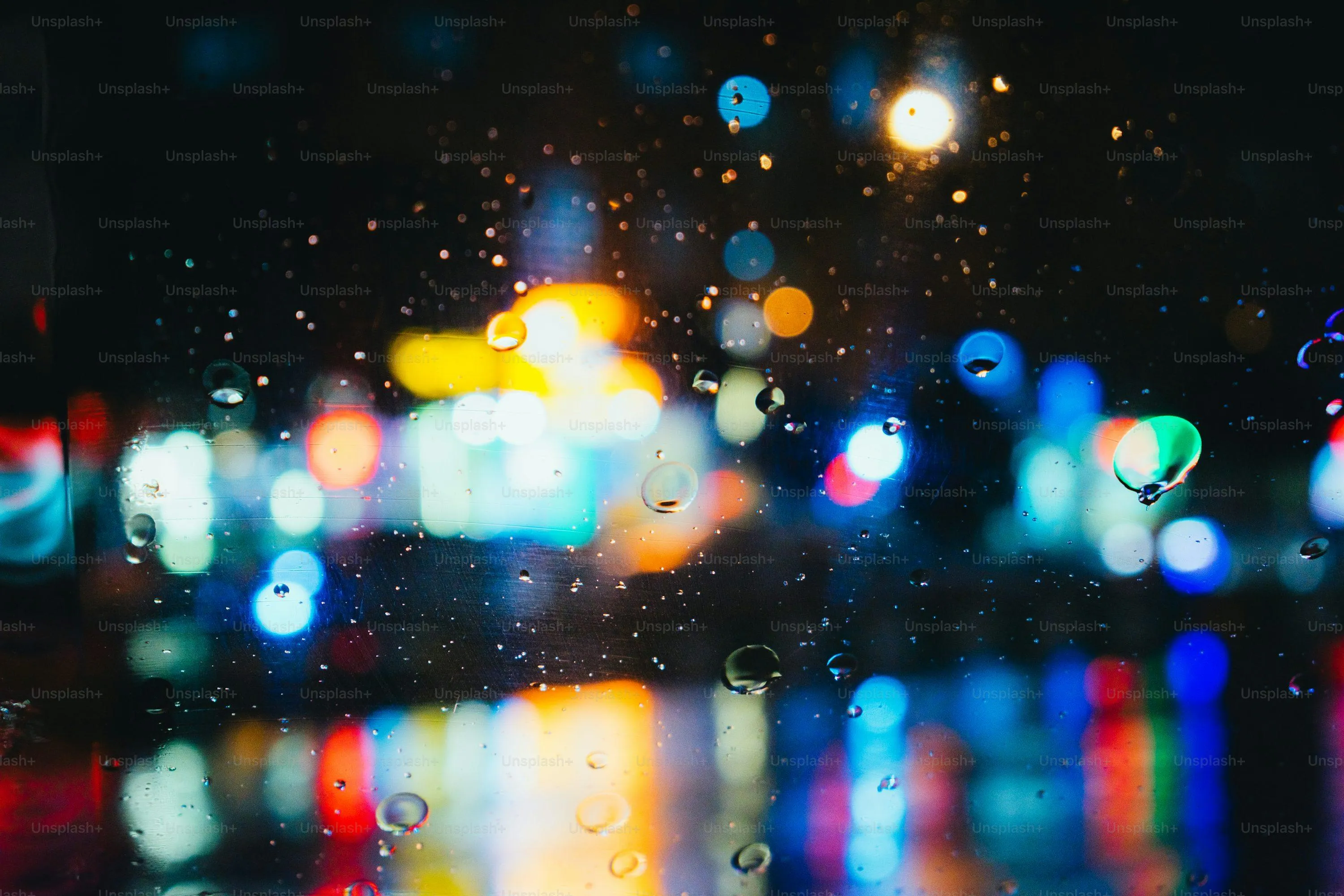 Colorful City Lights Blurred By Rainy Weather Wallpaper