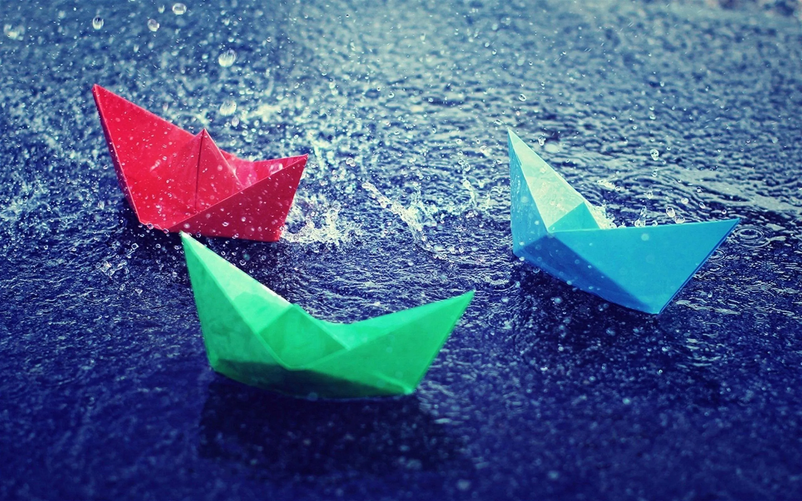 Colorful Paper Boats Floating on Raincovered Water