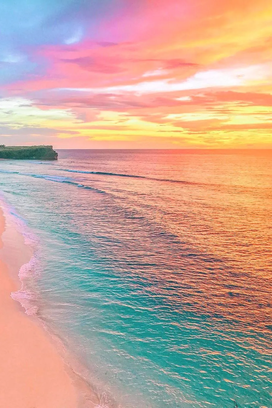 Colorful Sunrise Over Calm Ocean Waters and Sandy Beach