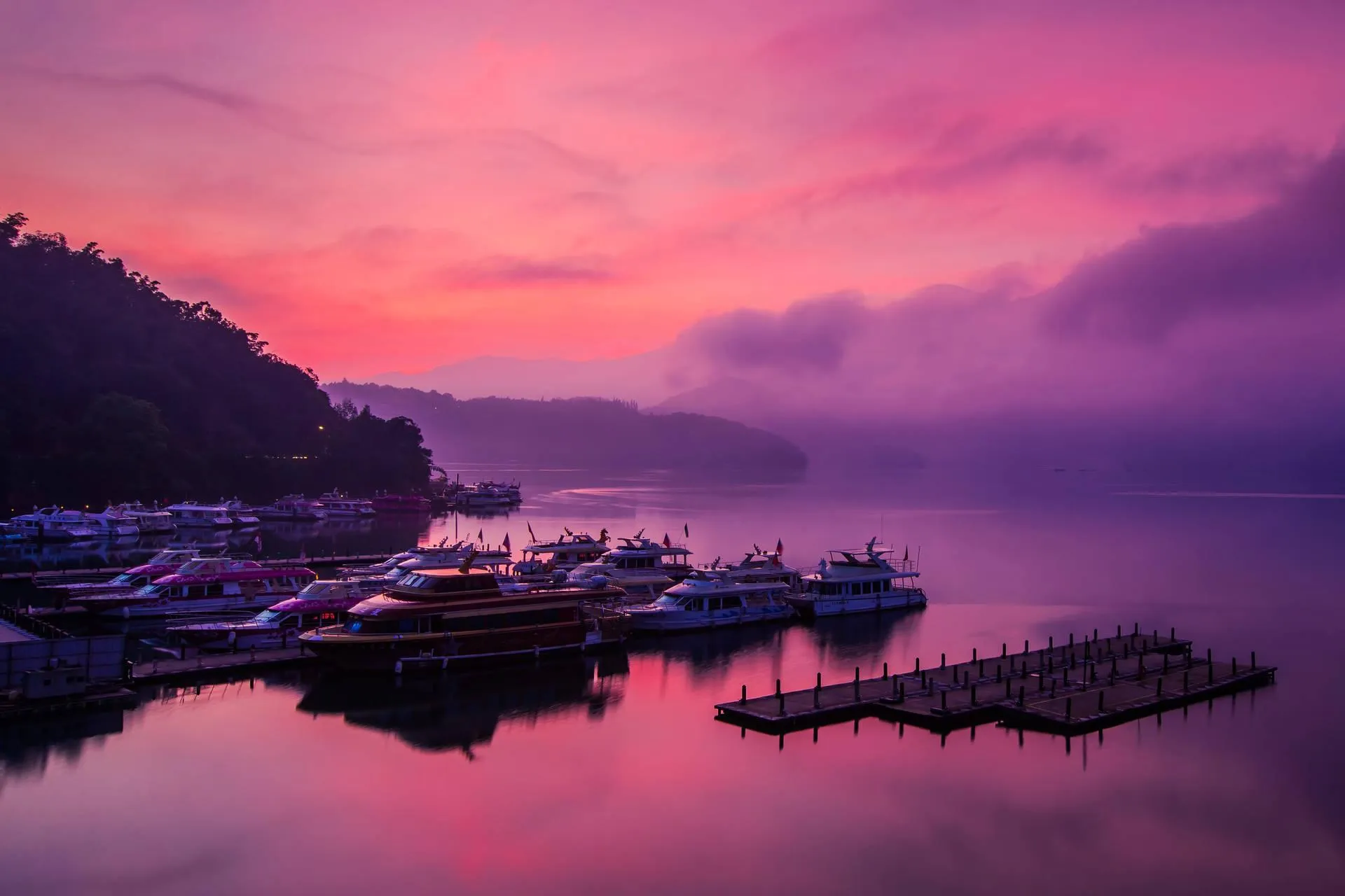 Colorful Sunset Over Quiet Harbor with Boats Docked