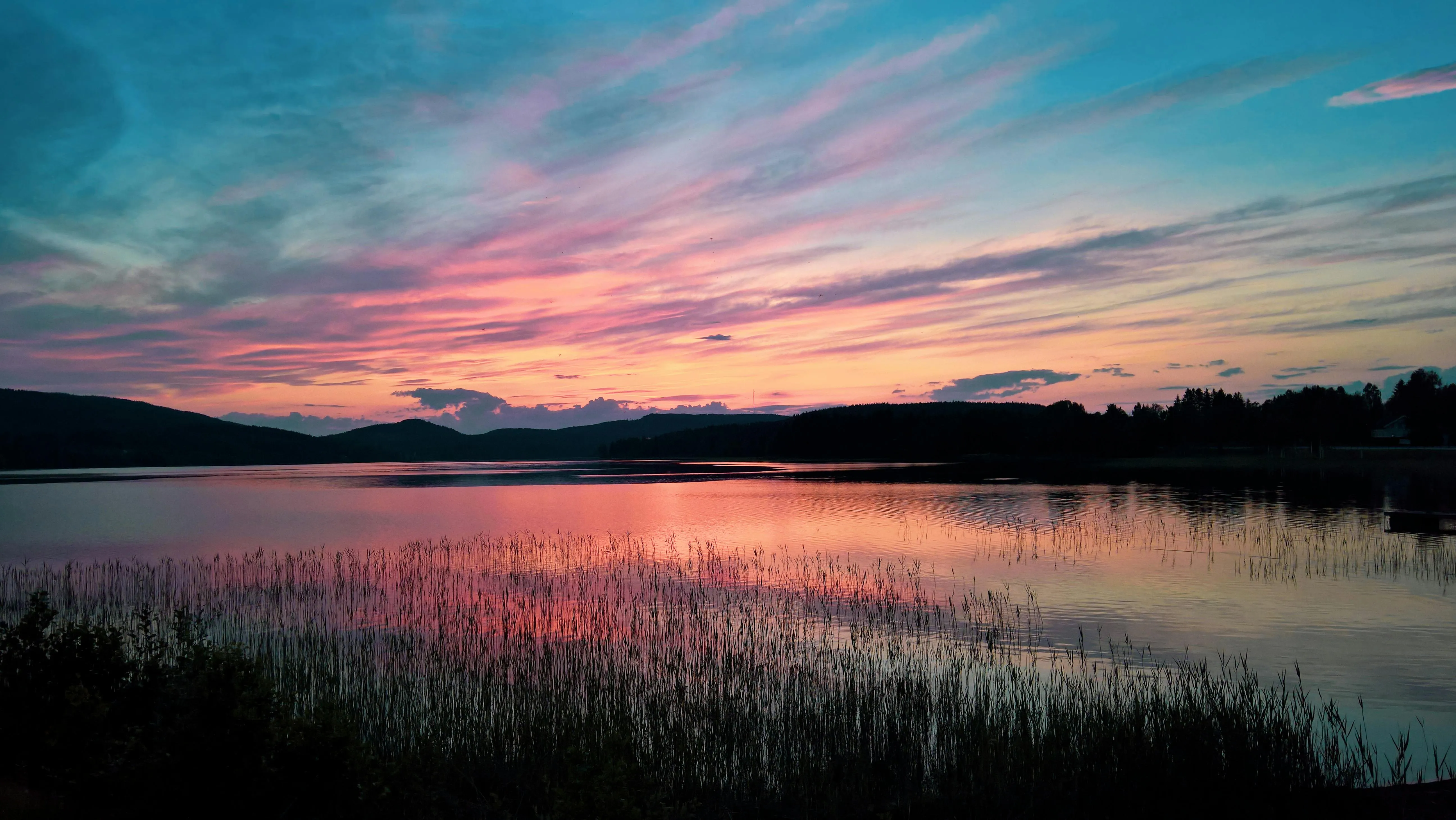 Colorful Sunset Sky Over Silhouetted Mountain Range