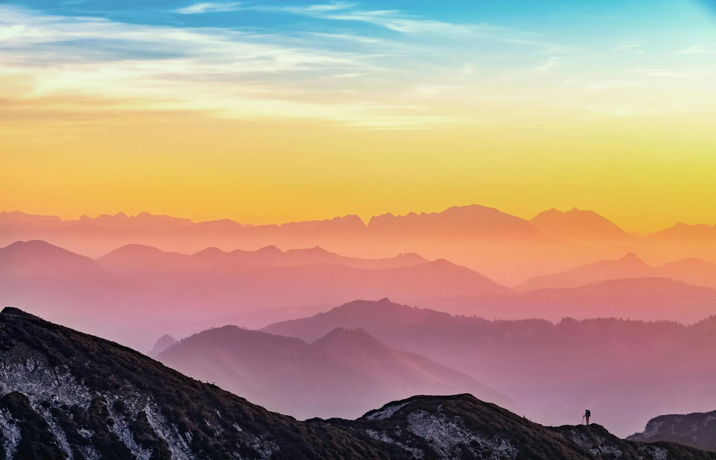 Colorful Sunset with Layered Mountains in Background