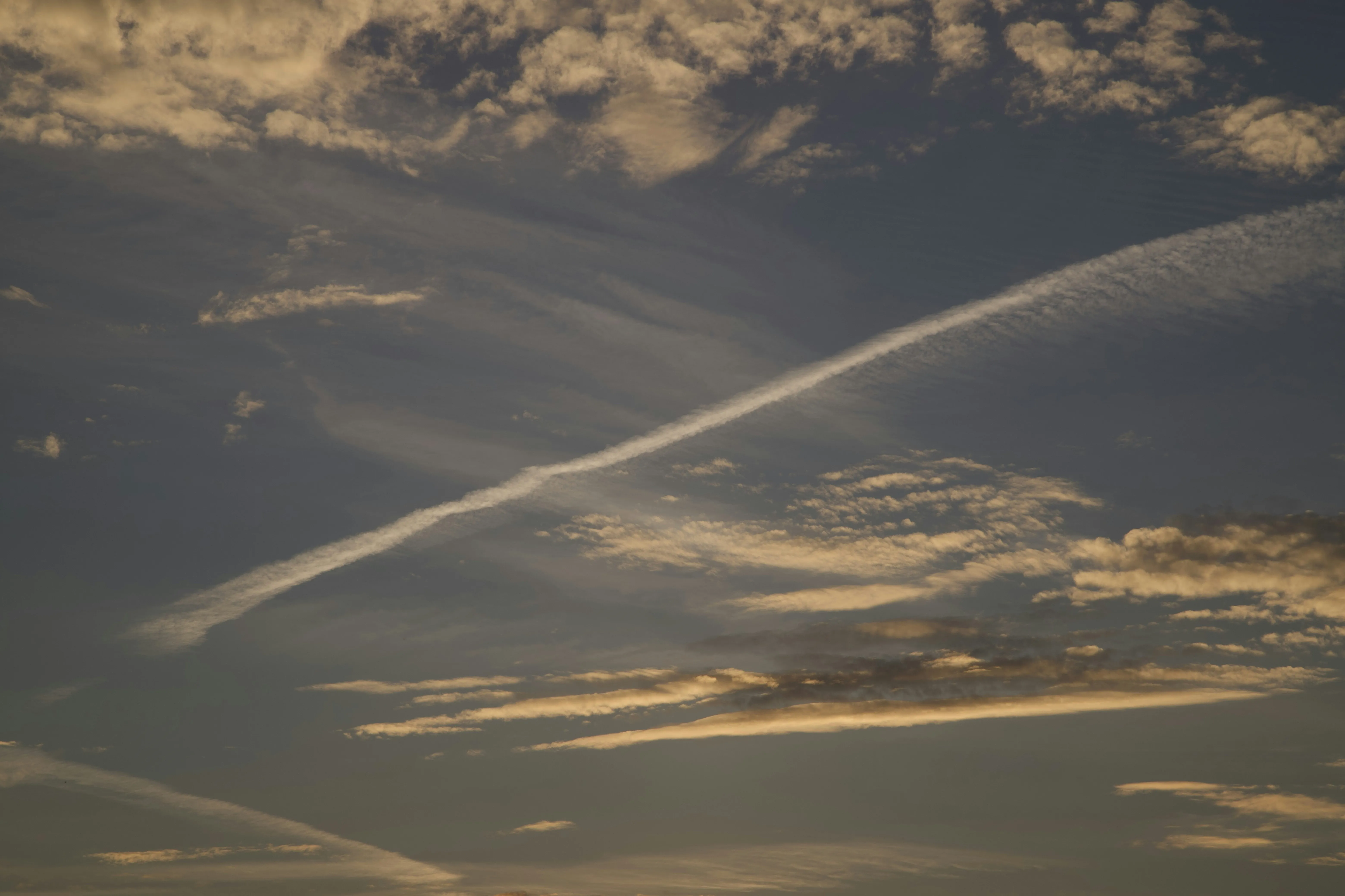 Contrails and Clouds During Golden Hour Sunset Wallpaper