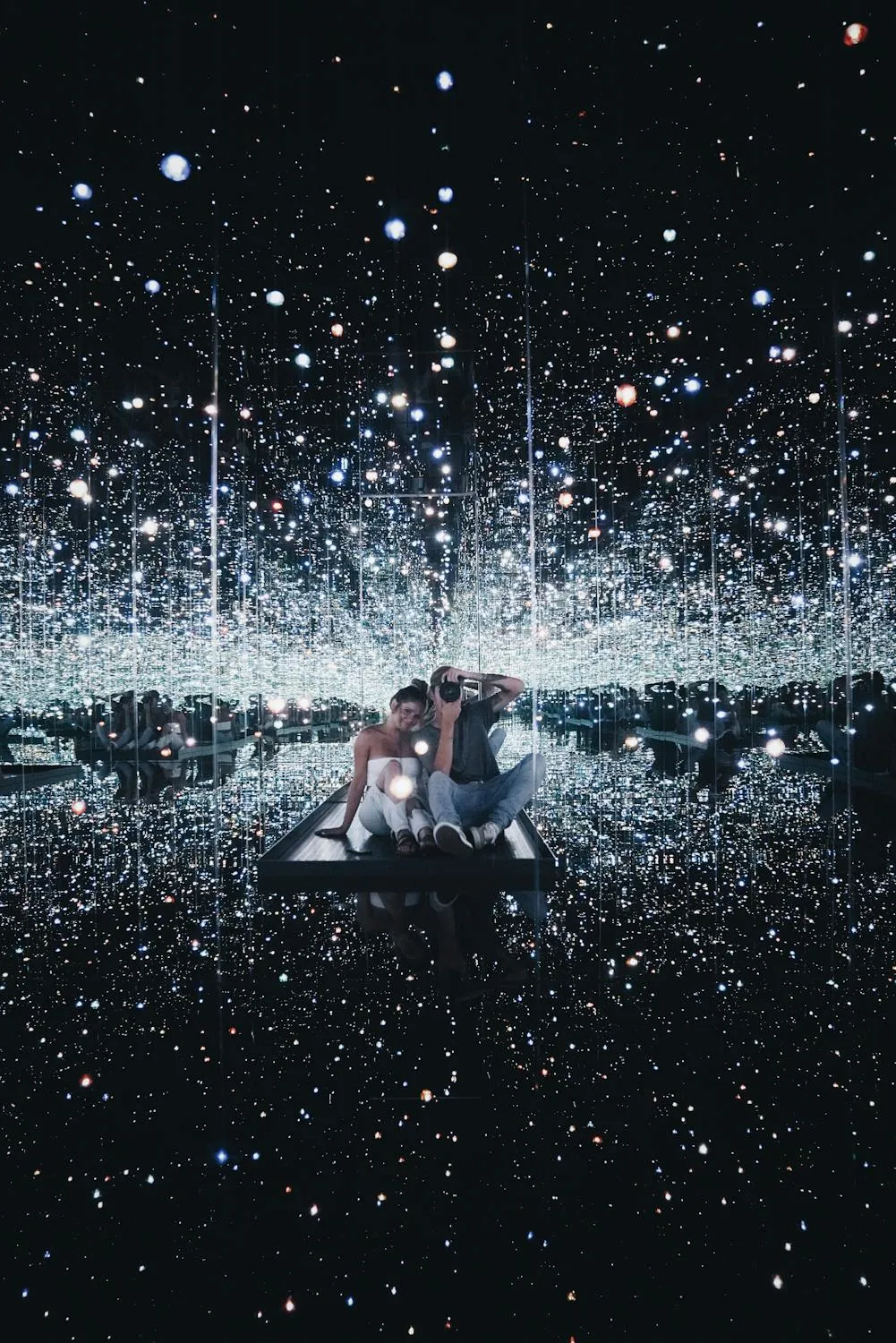 Couple Sitting in Infinity Mirror Room Art Wallpaper