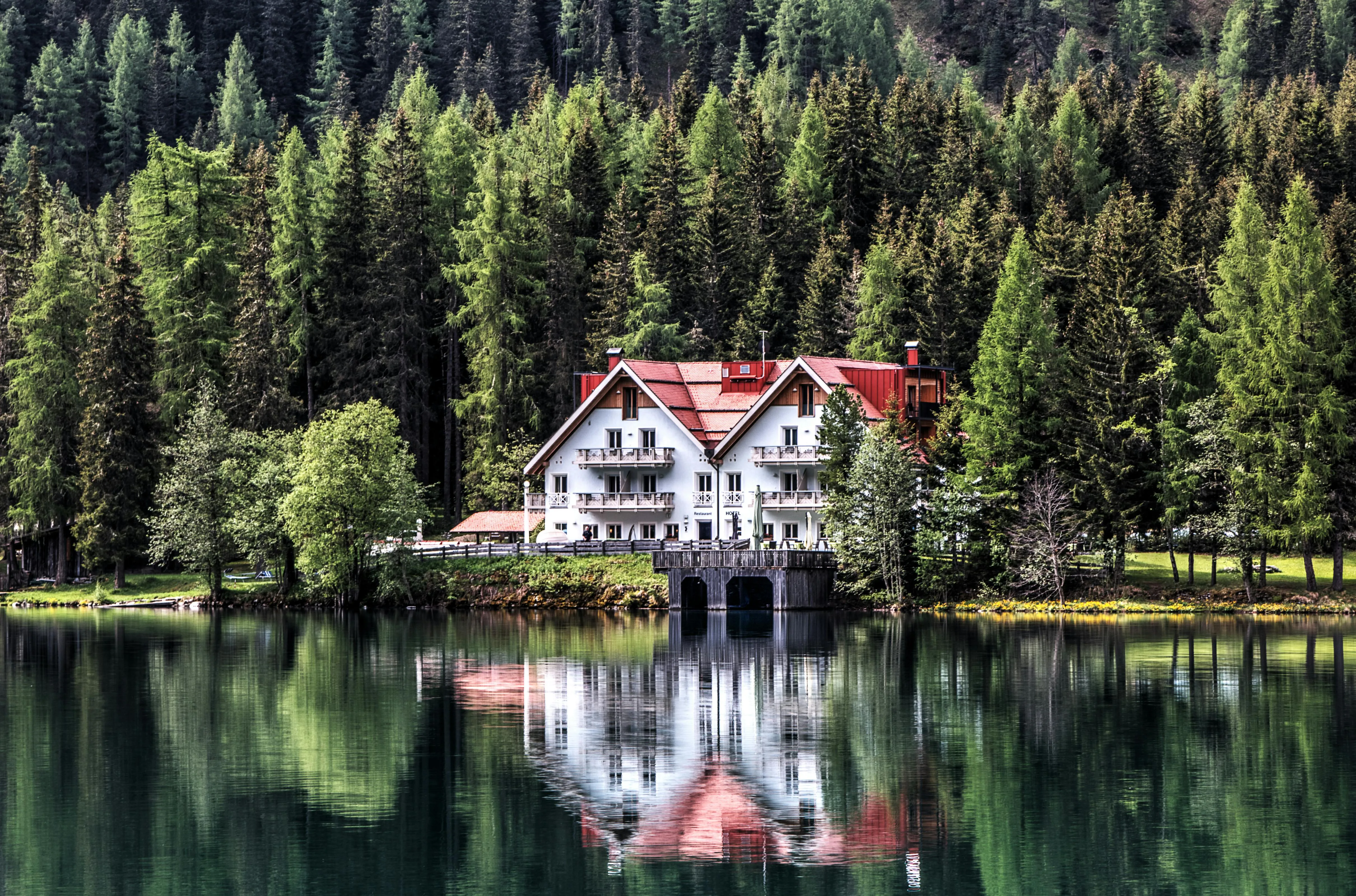 Cozy House Reflected on a Calm Lake Surrounded by Forest