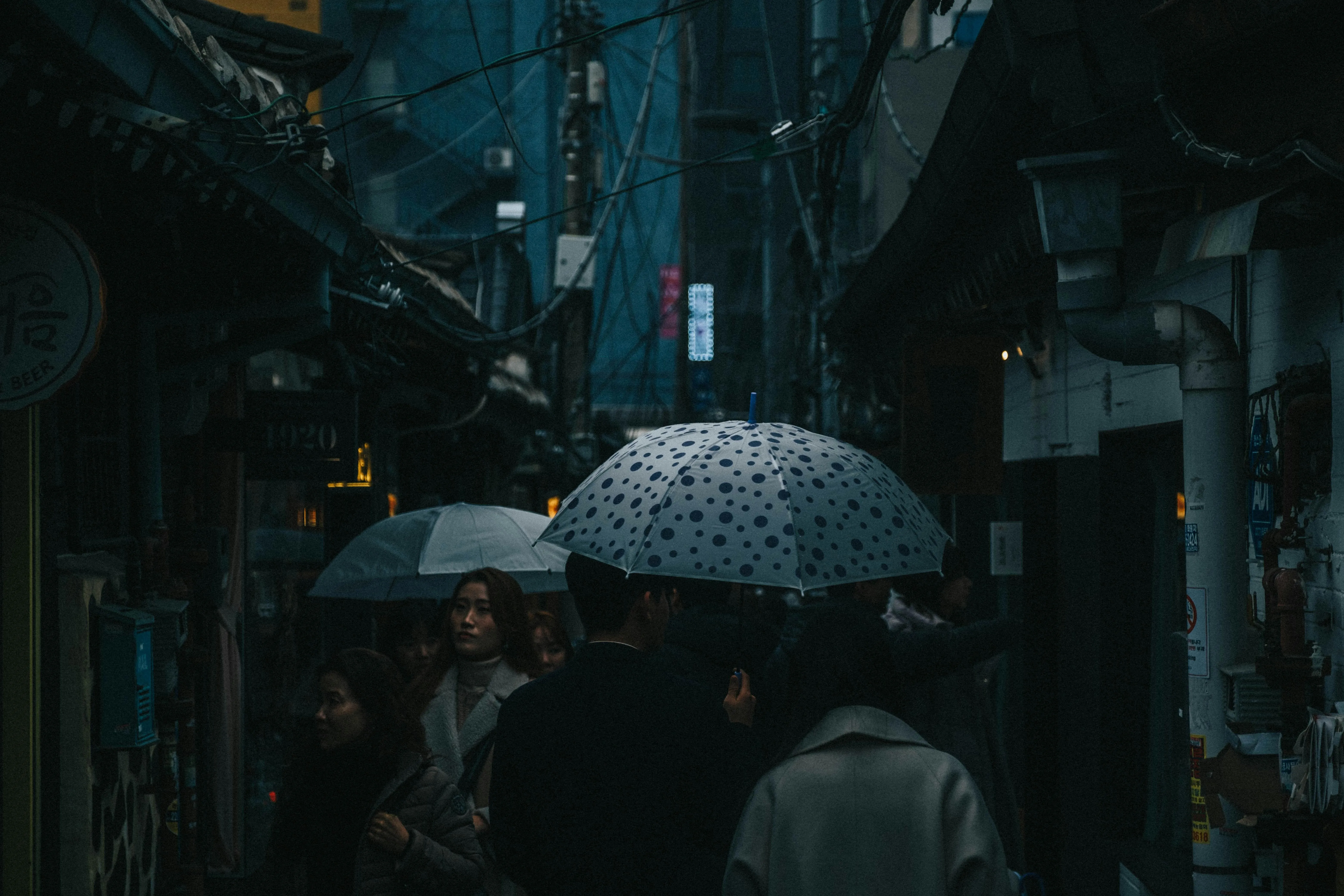 Crowd with Umbrellas Under Rain at Night Market Wallpaper