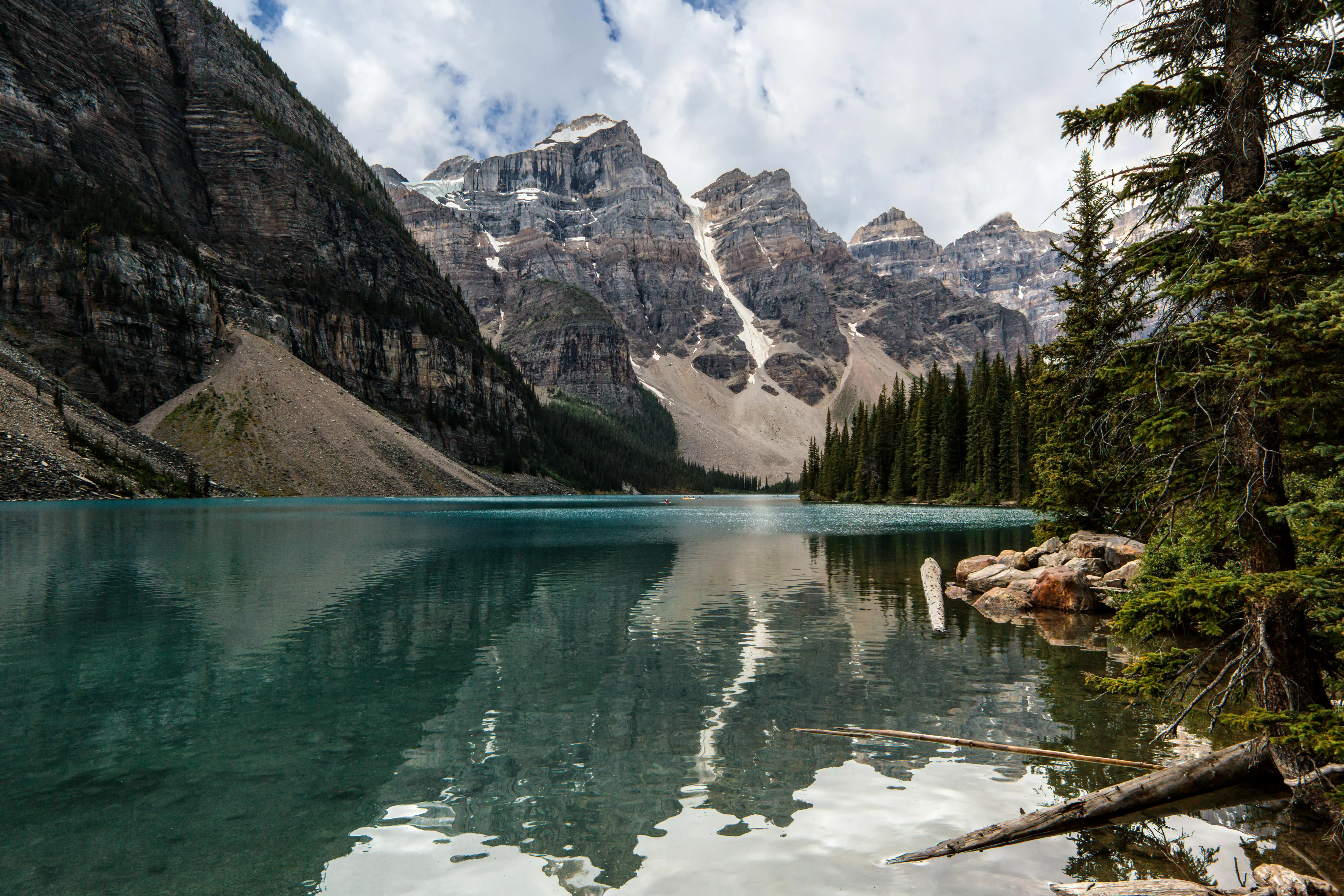Crystal Clear Lake Reflecting Trees and a Rocky Mountain