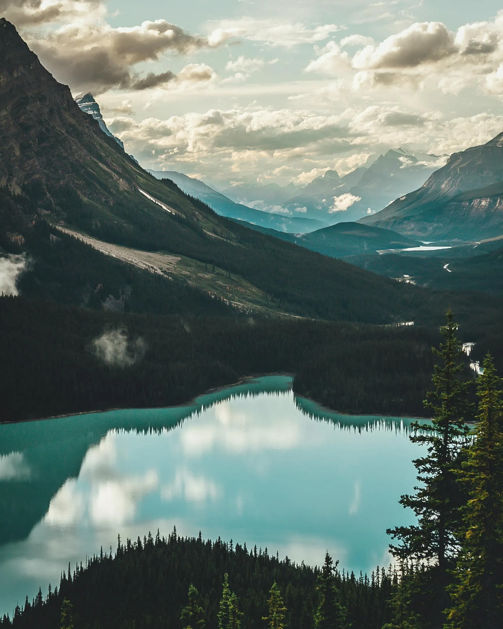 Crystal Clear Lake with Clouds and Mountain Reflections