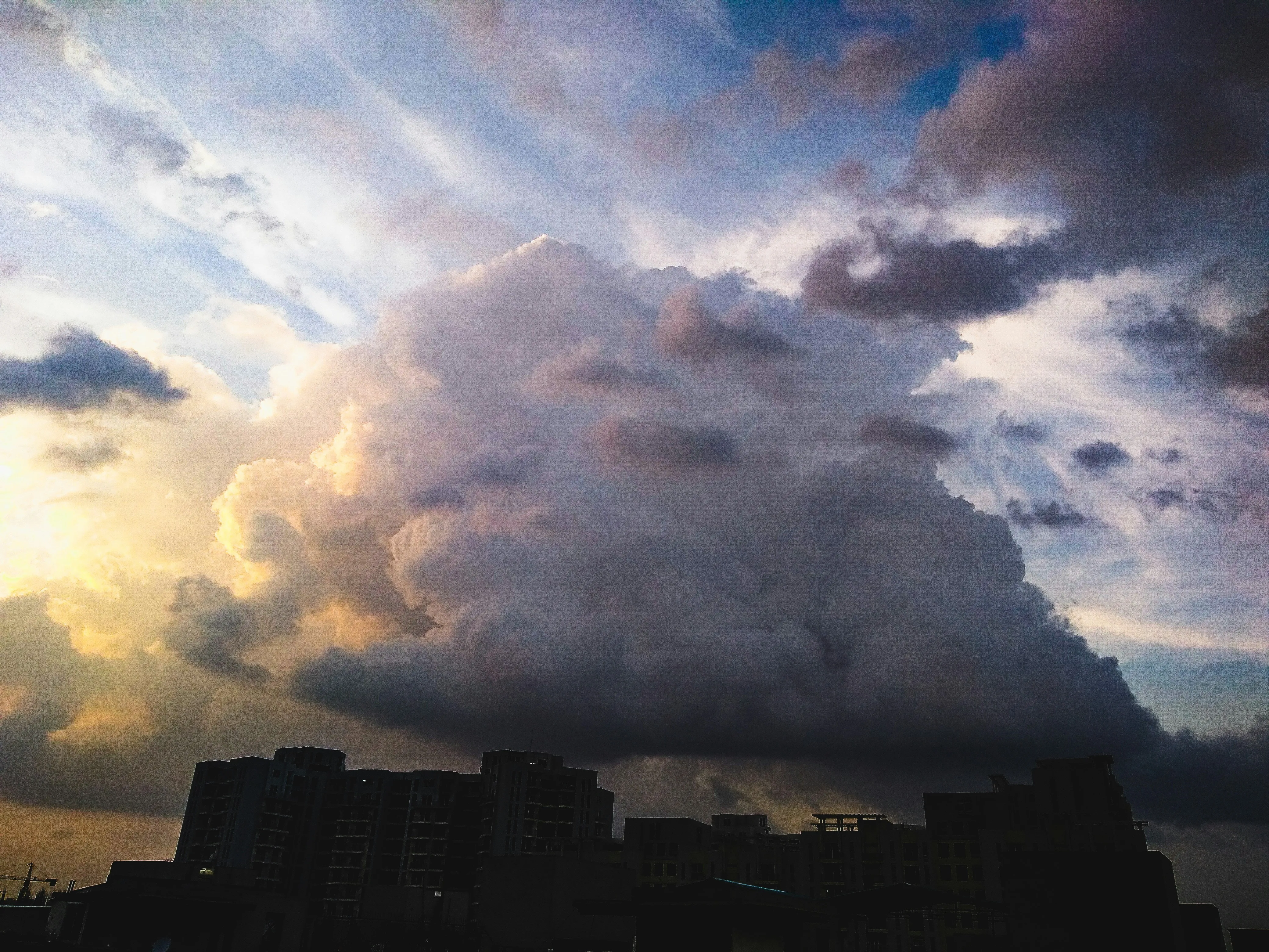 Dark and Heavy Clouds Over City Skyline Before Storm