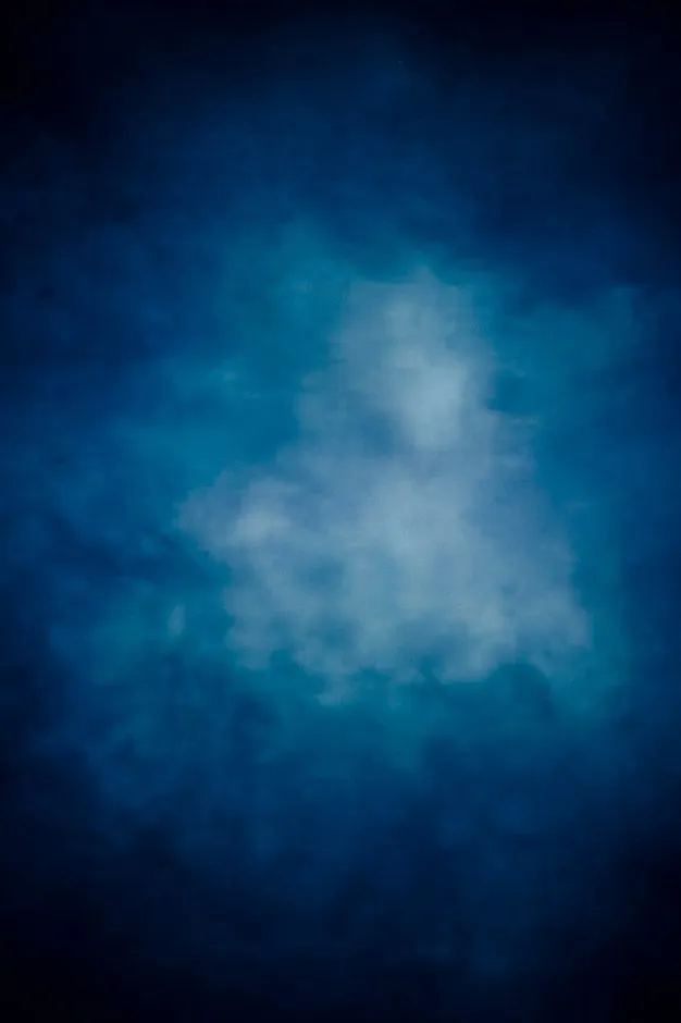 Dark Blue Cloudy Sky with Soft Glow in the Center Wallpaper