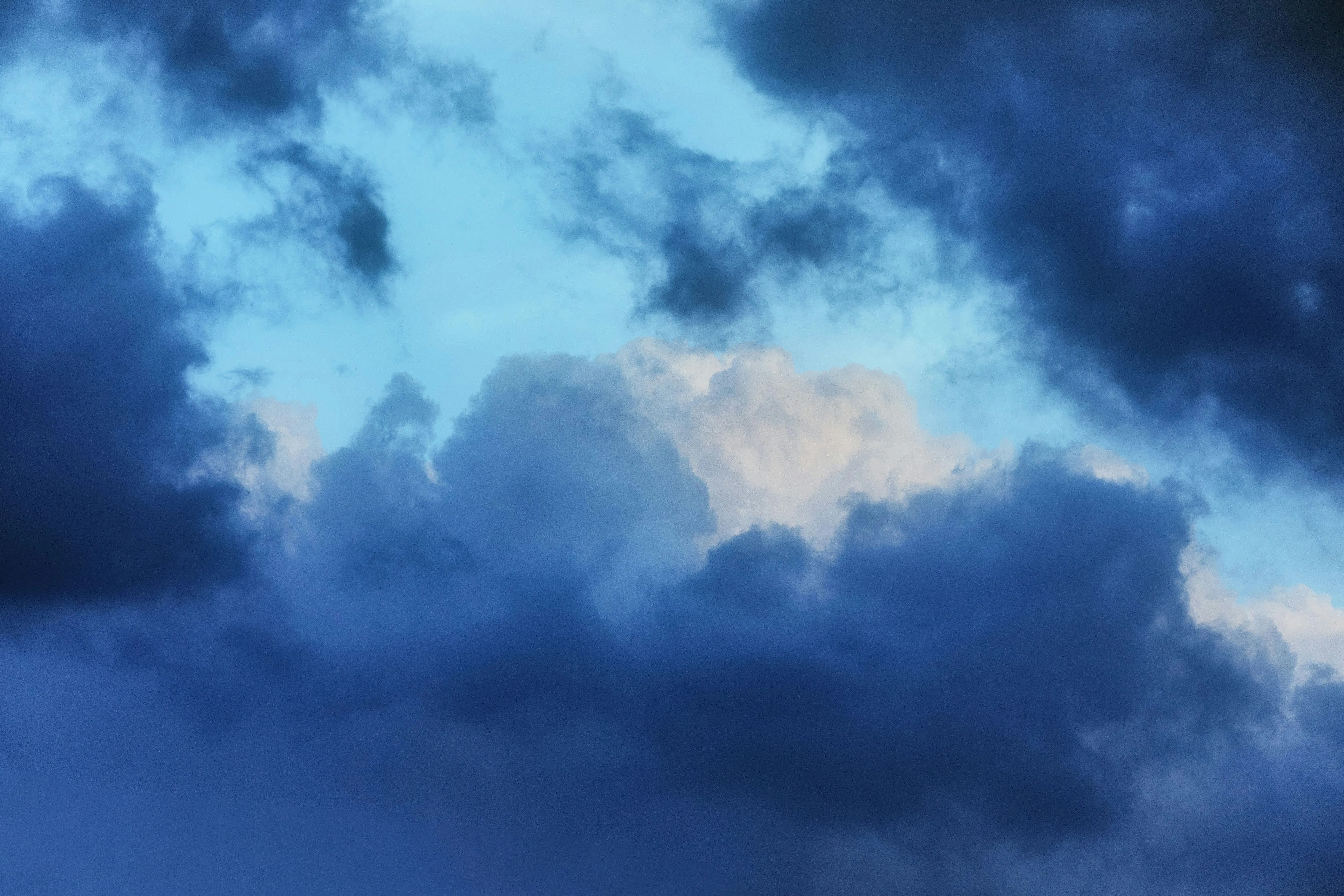 Dark Blue Evening Sky with Rolling Thick Storm Clouds
