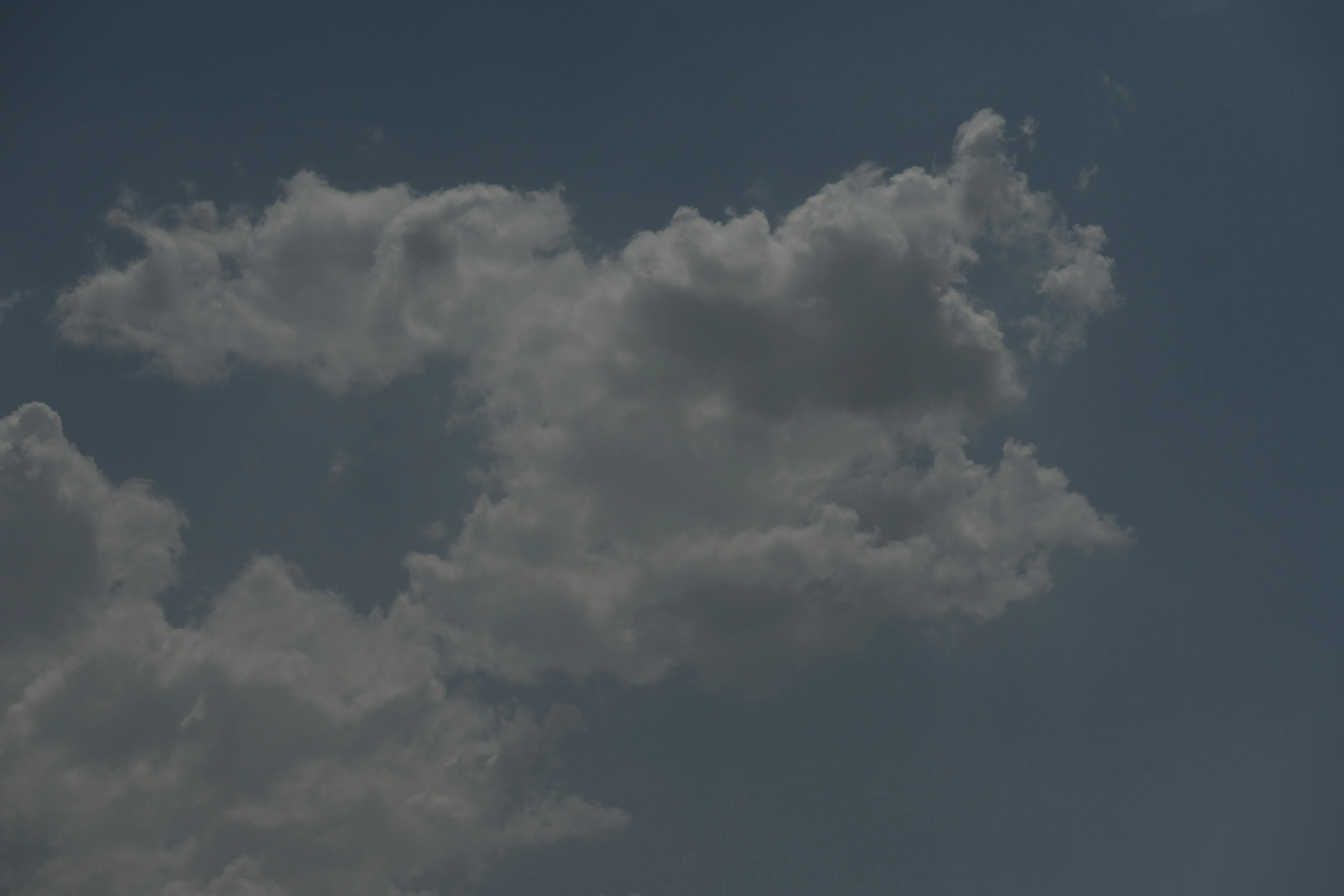 Dark Cloud Formation Against Deep Blue Sky Backdrop