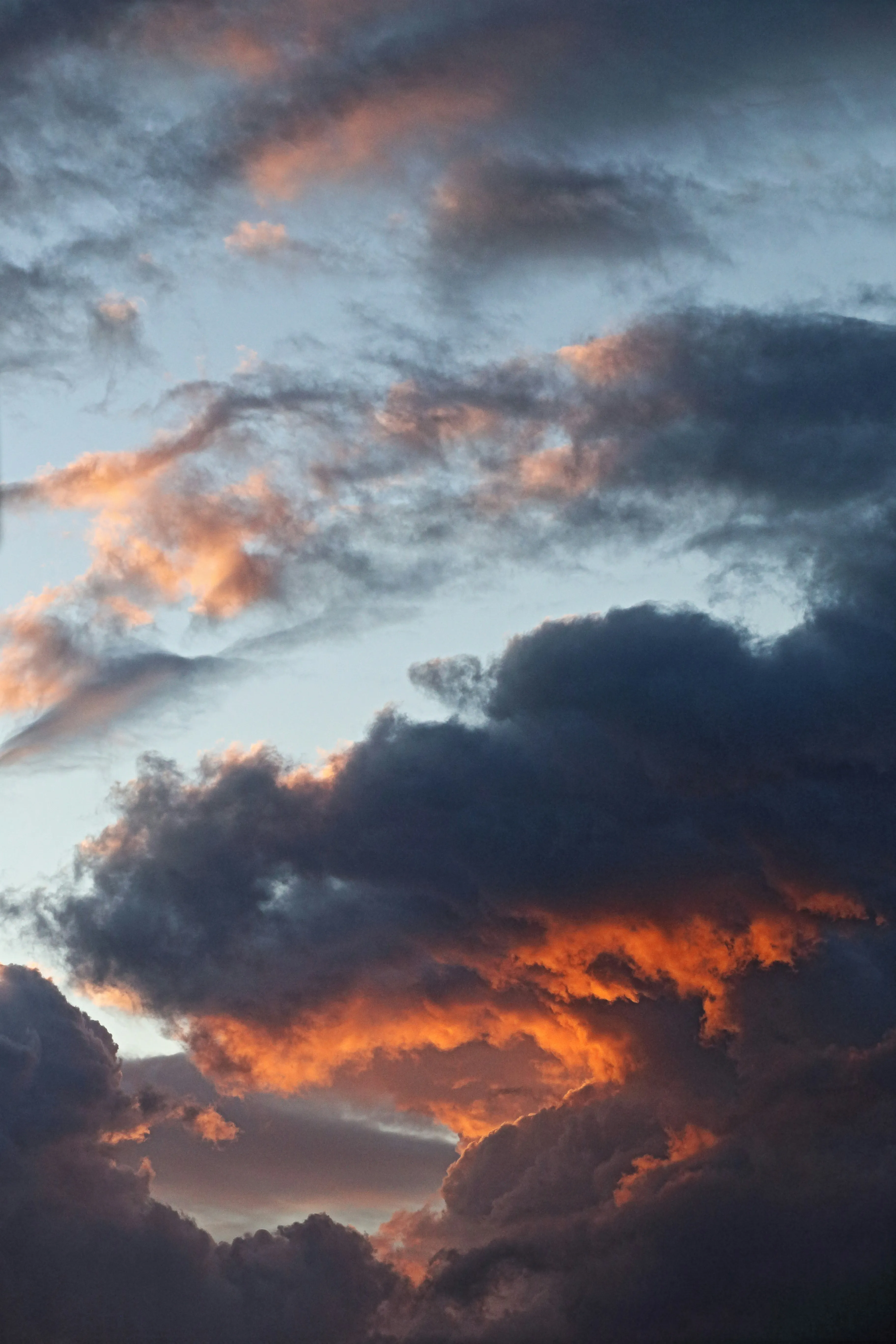 Dark Clouds with Fiery Glow During Dramatic Sunset Image
