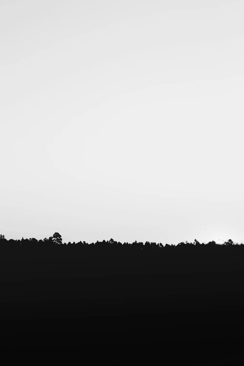 Dark Hill Silhouette Under a Clean Gradient Sky Image