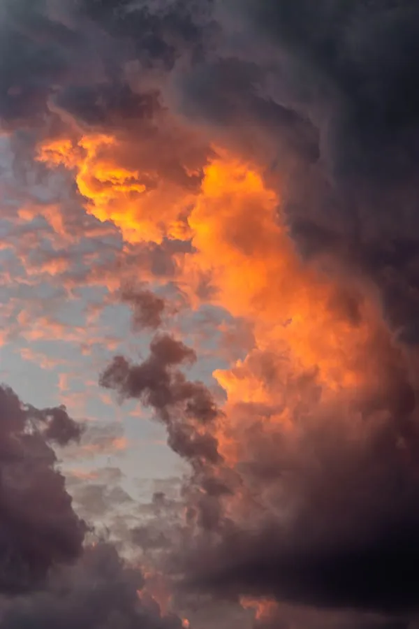 Dark Orange Storm Clouds Glowing at Sunset in Sky Wallpaper