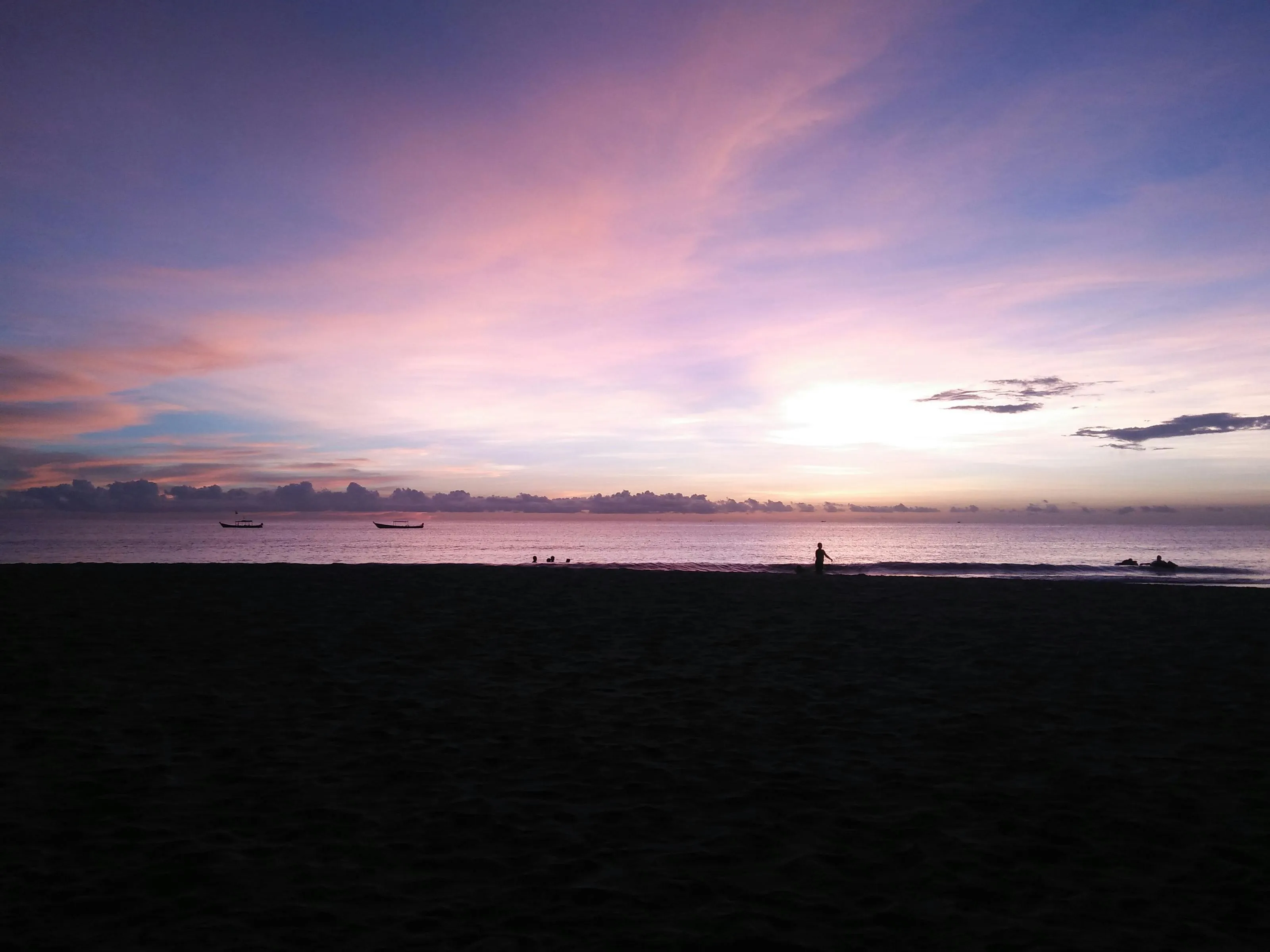 Dark Silhouetted City Skyline with Colorful Sunset Clouds