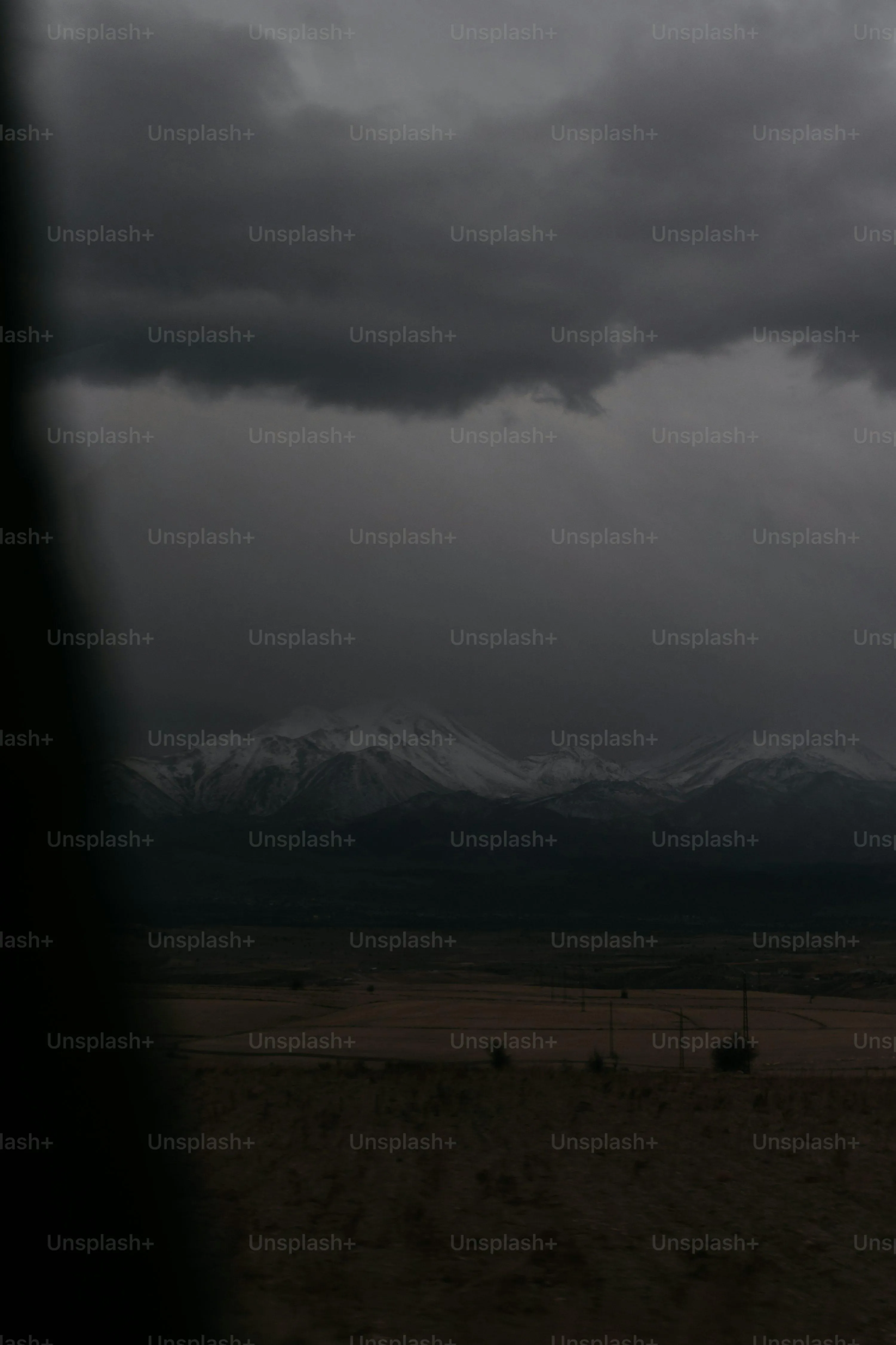 Dark Storm Clouds and Rain Over Rural Landscape at Dusk