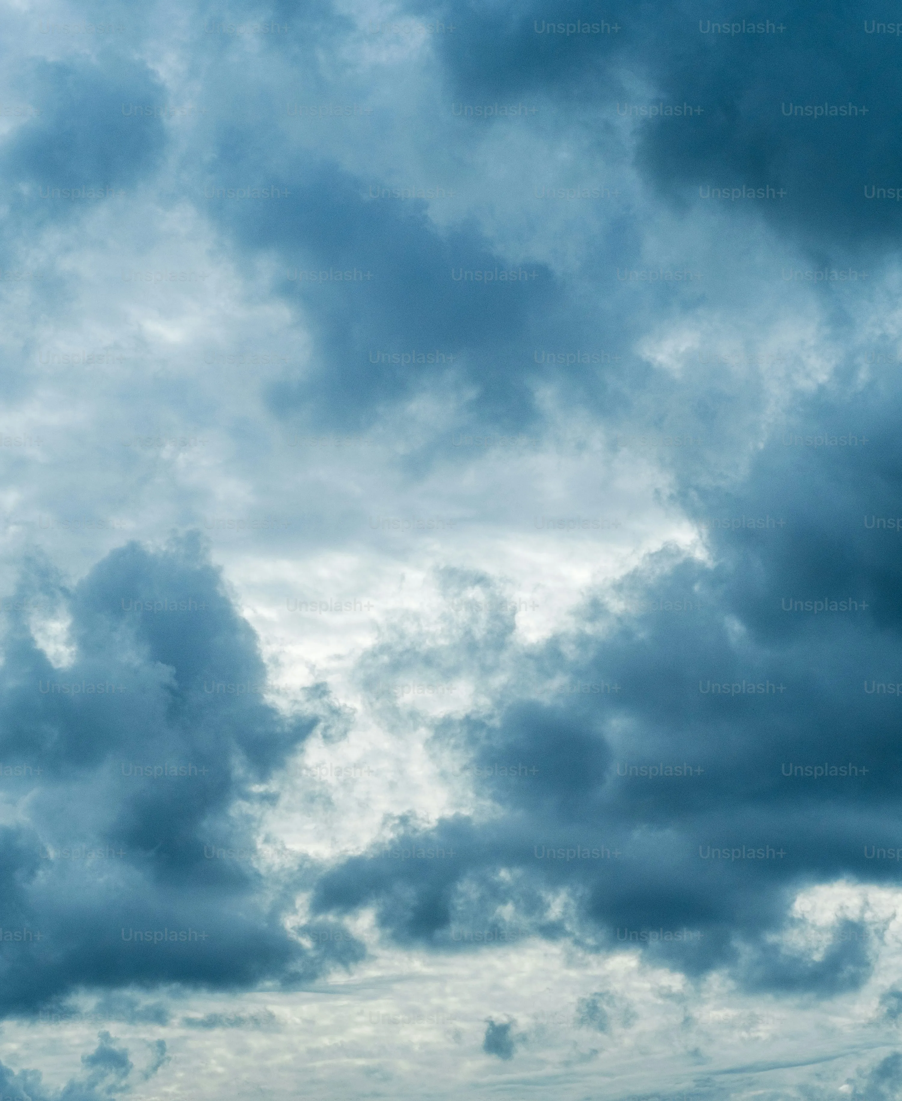 Dark Storm Clouds Gathering Over Cloudy Sky and Landscape