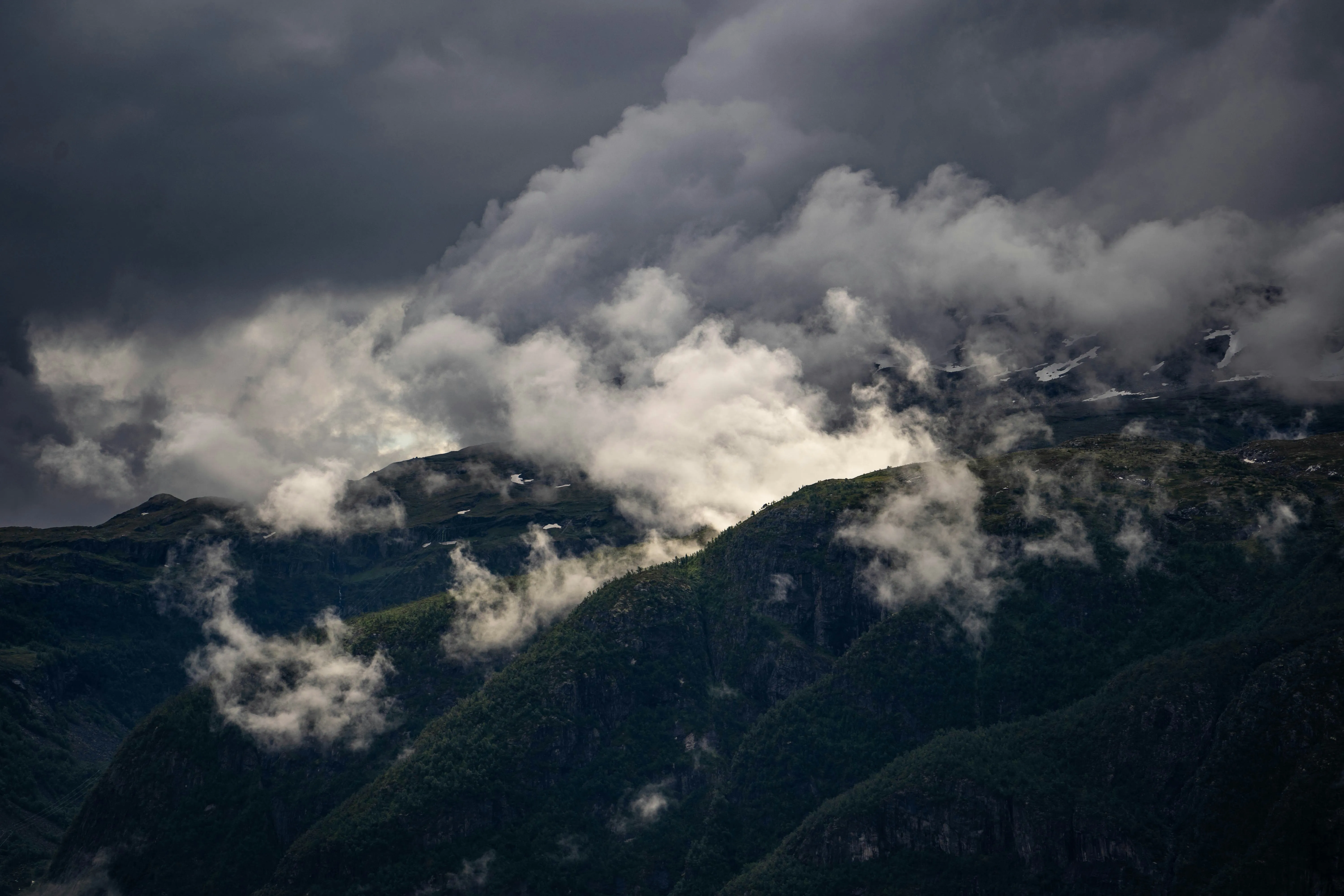 Dark Storm Clouds Gathering Over Mountain Peaks at Dusk