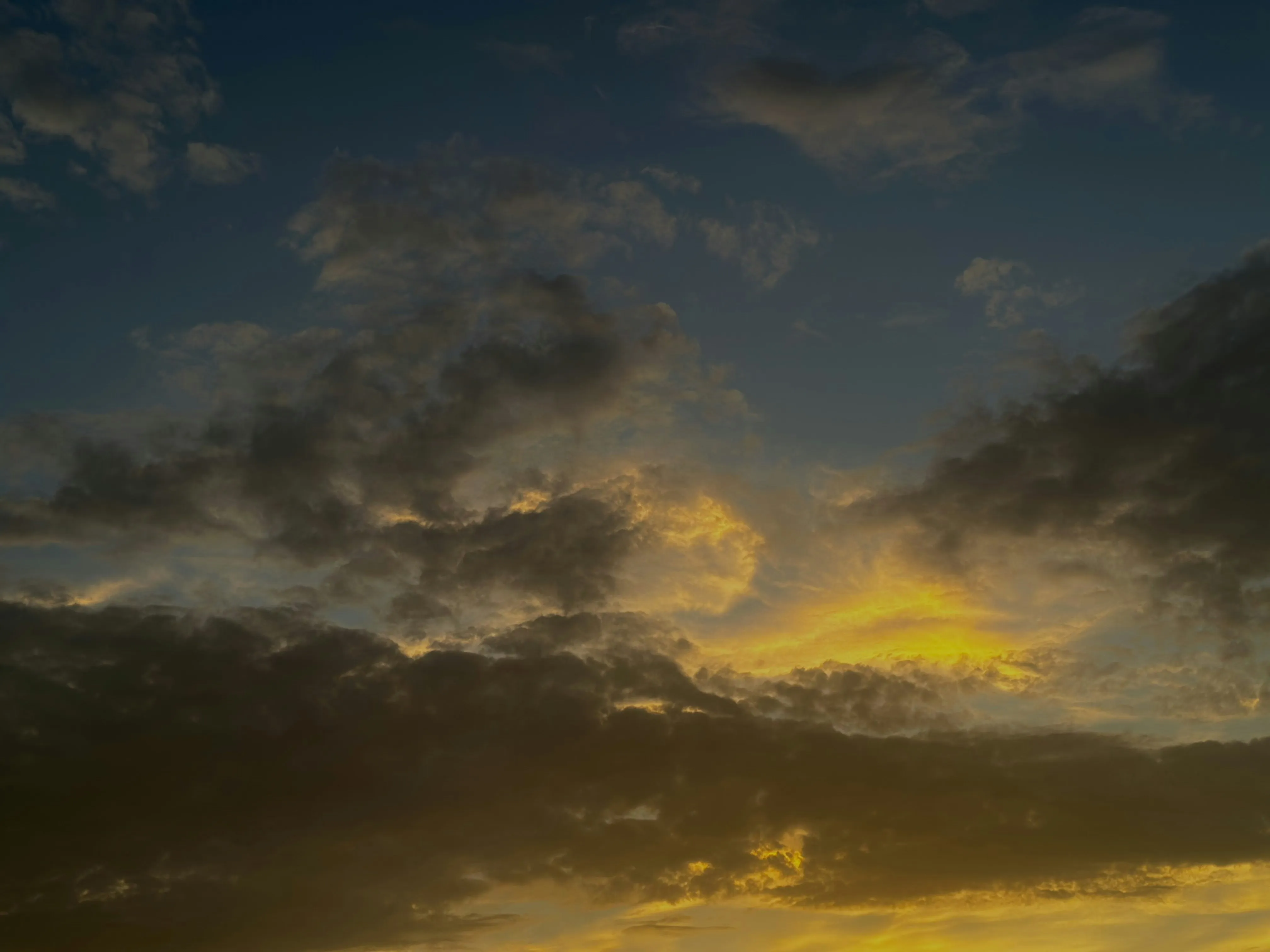 Dark Stormy Clouds Over Horizon at Golden Sunset Image