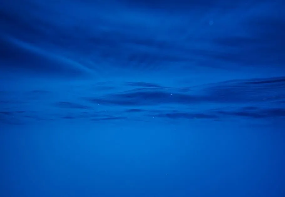 Deep Blue Ocean Waters Blending Into Nightfall Skies