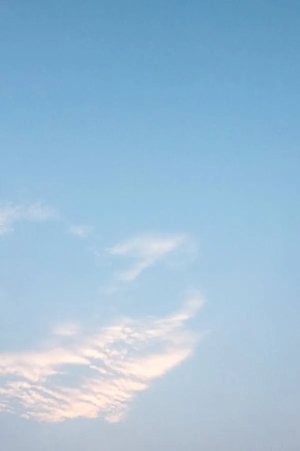 Delicate Cloud Patterns in a Soft Blue Daytime Sky Wallpaper