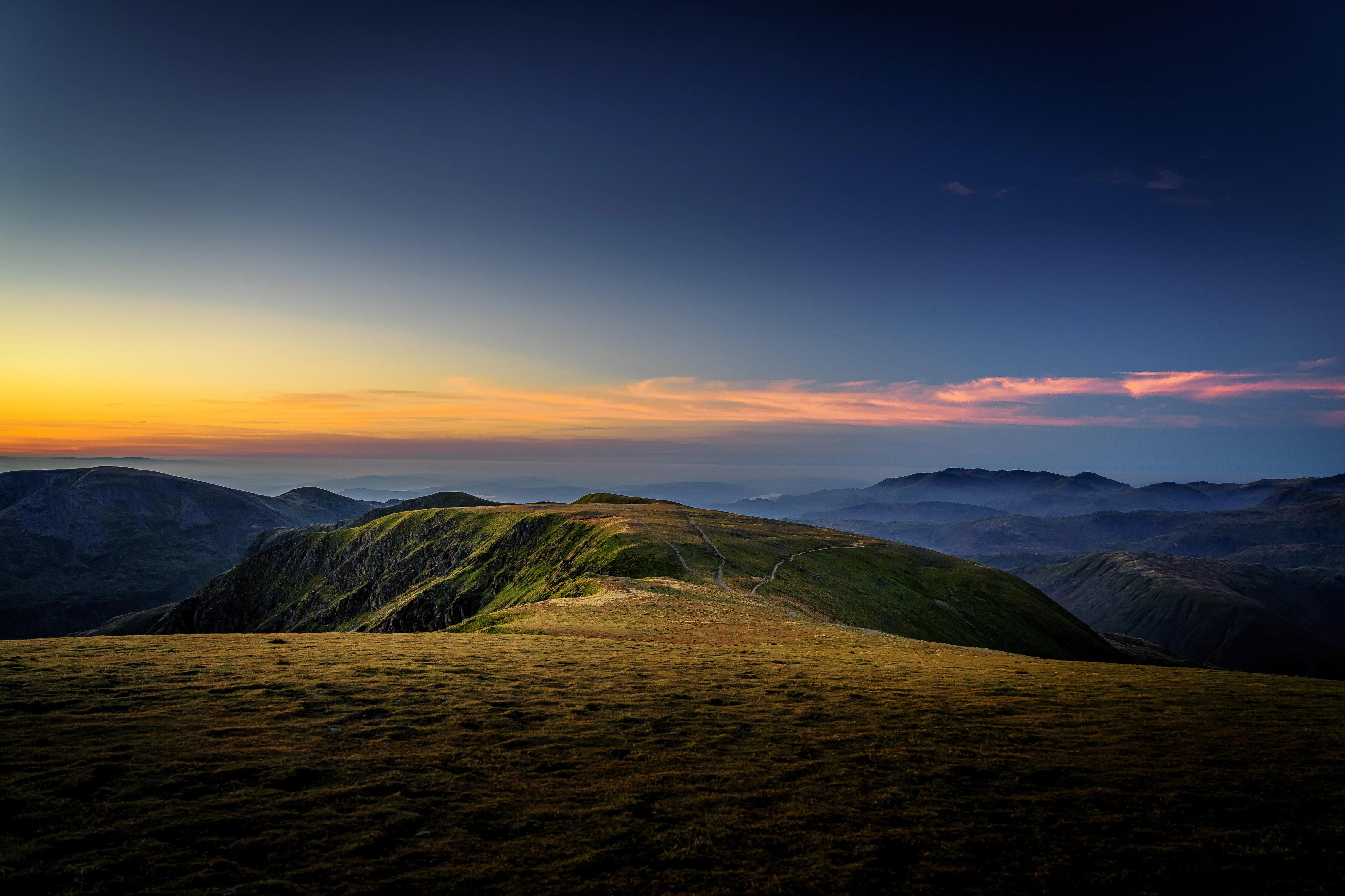 Desert canyon glowing at golden sunset hour Wallpaper