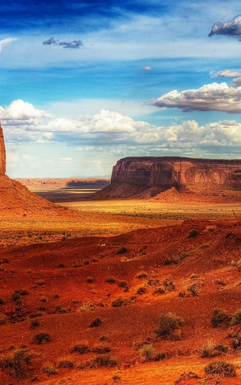 Desert Landscape with Red Rocks Under Partly Cloudy Sky