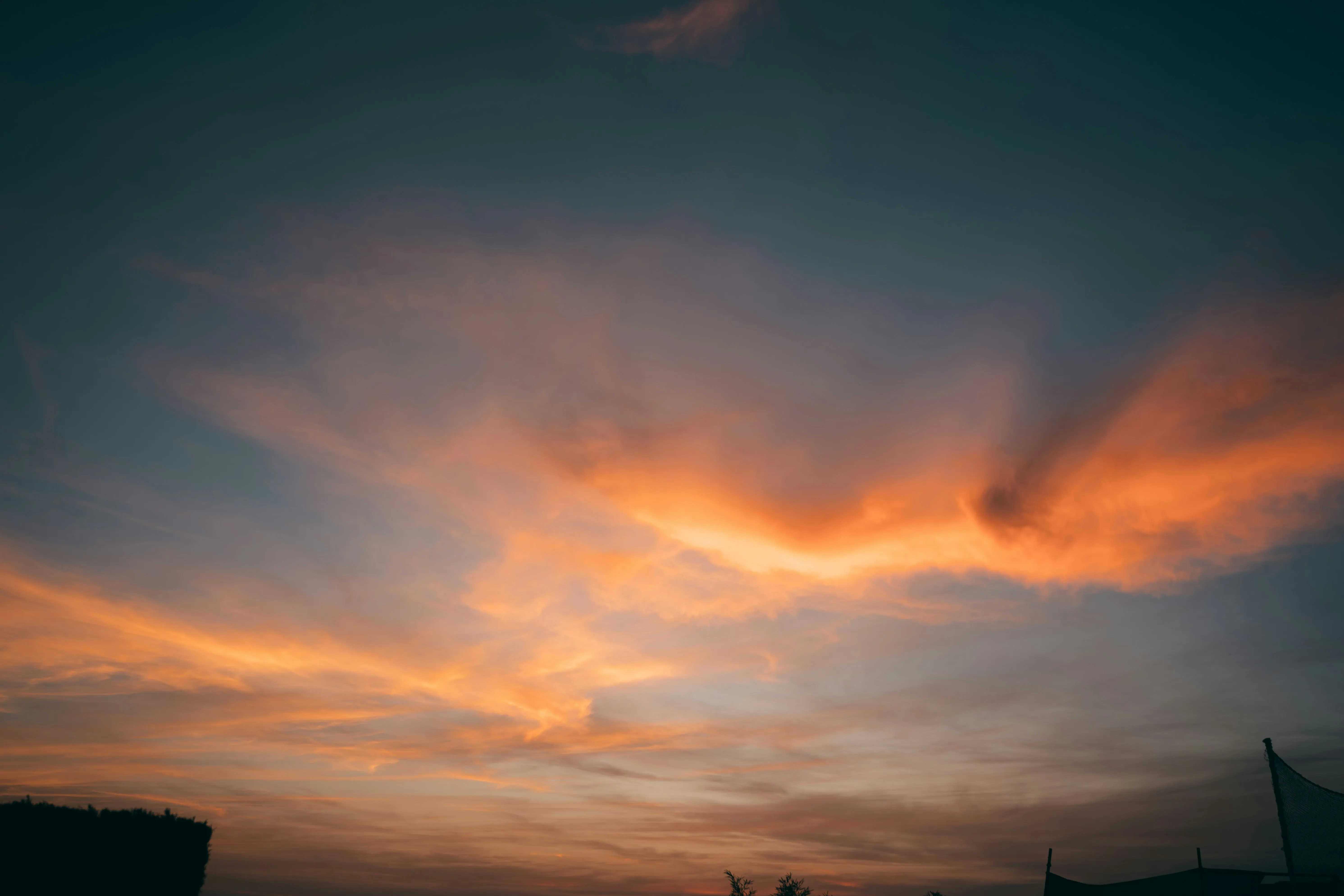 Dramatic Orange Clouds in Evening with Silhouette Trees