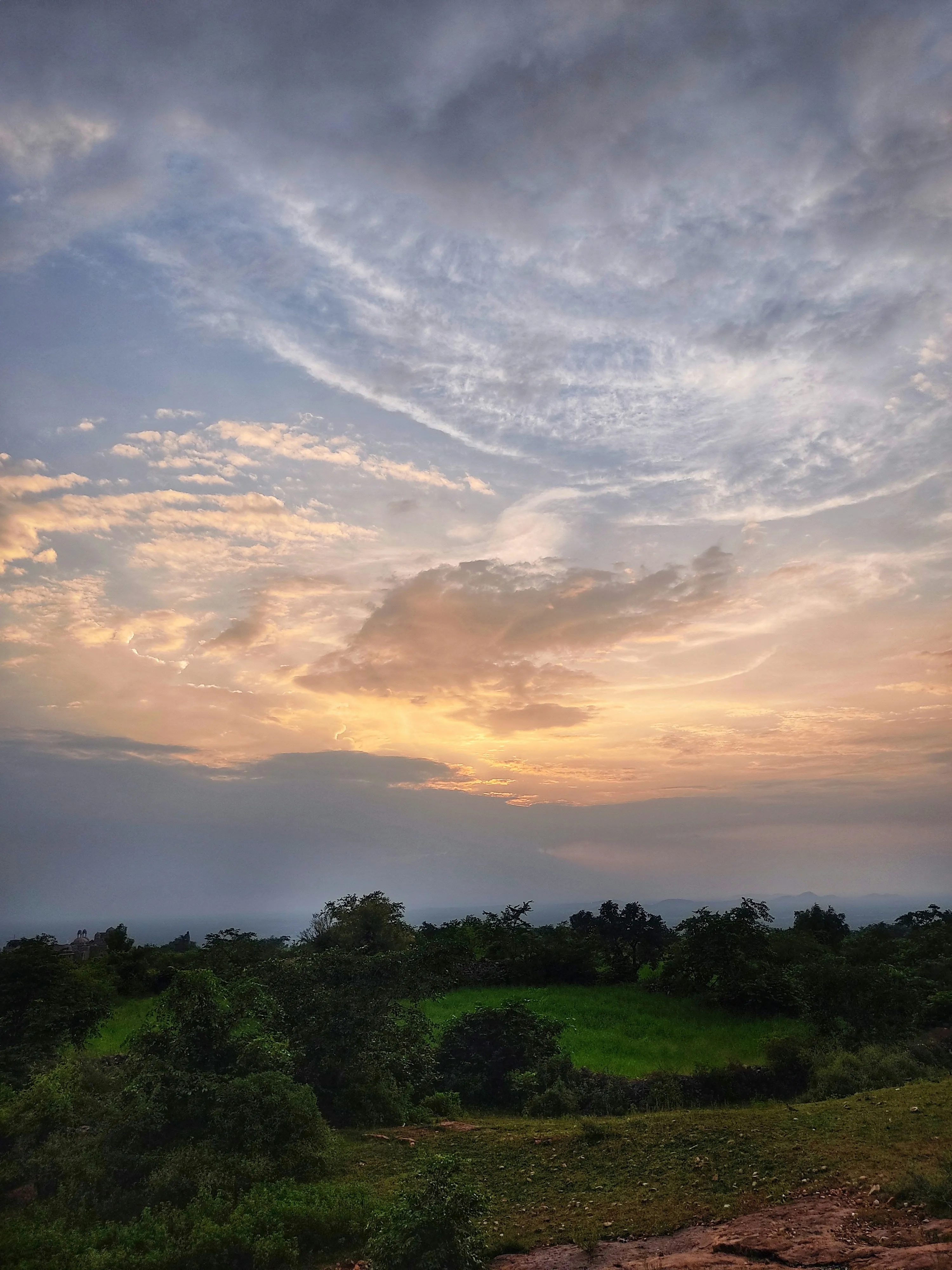 Dramatic Sky with Evening Clouds Over Trees and Hills