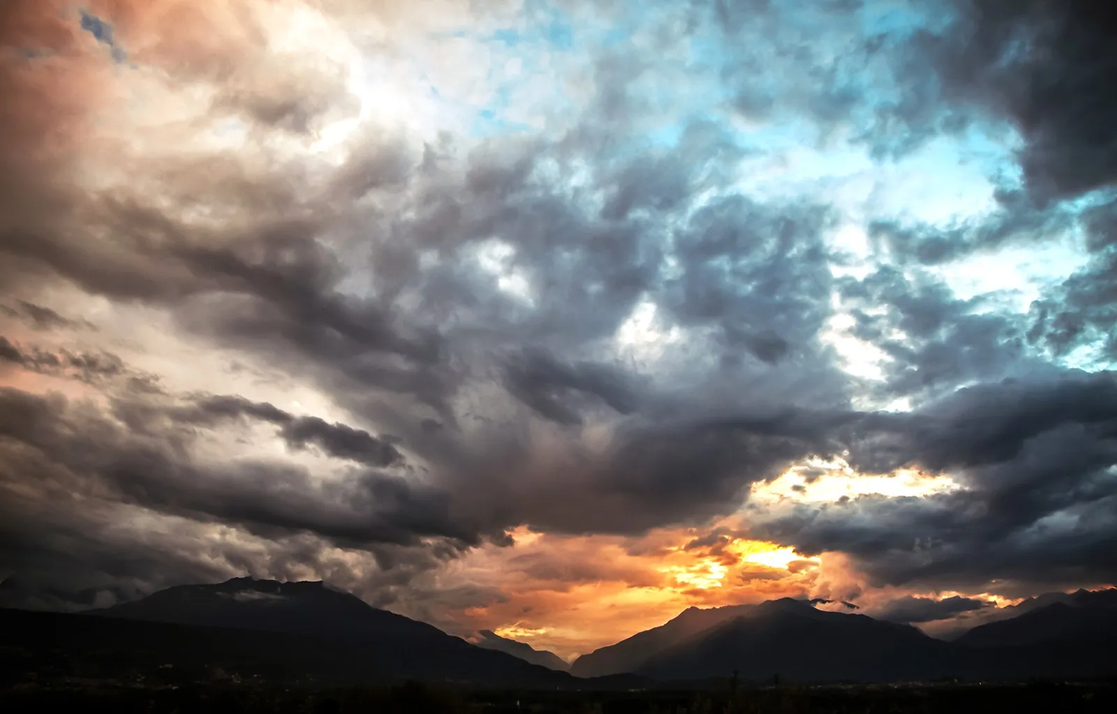 Dramatic Sunset Sky with Dark Clouds and Orange Light