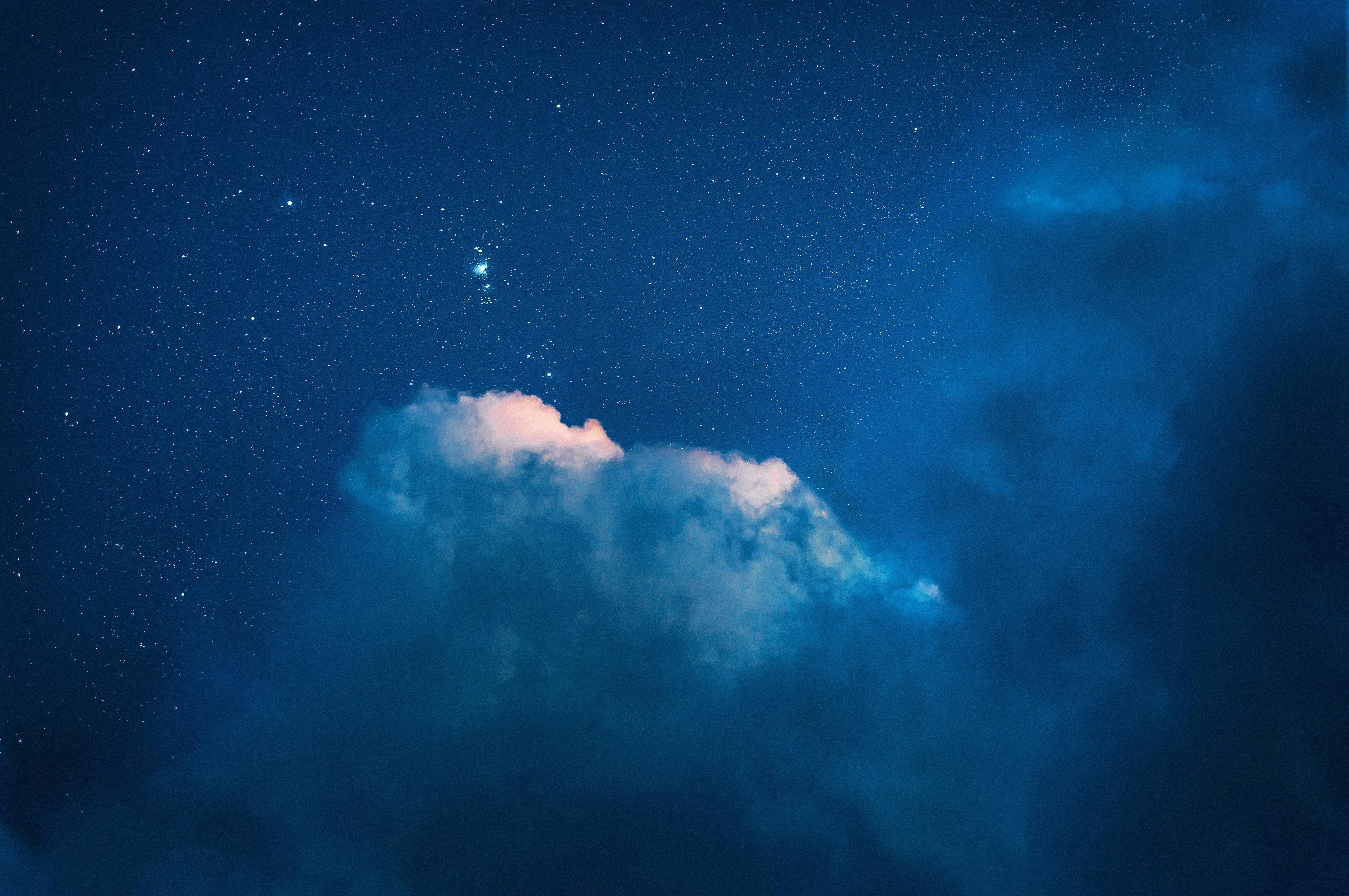 Dreamy Night Sky with Glowing Cloud Formations and Starlight