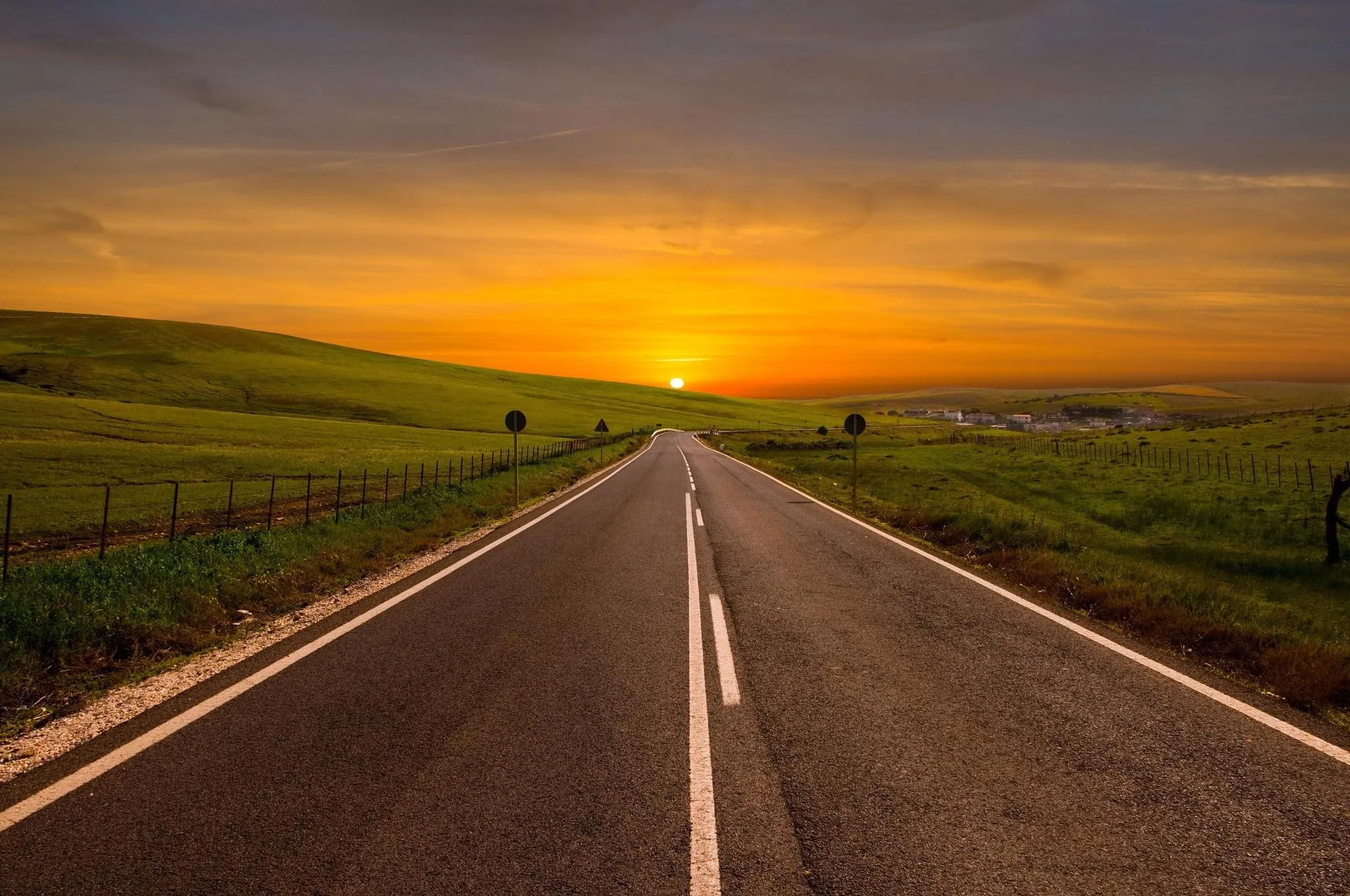 Empty Highway Road Leading Into Bright Sunset Wallpaper