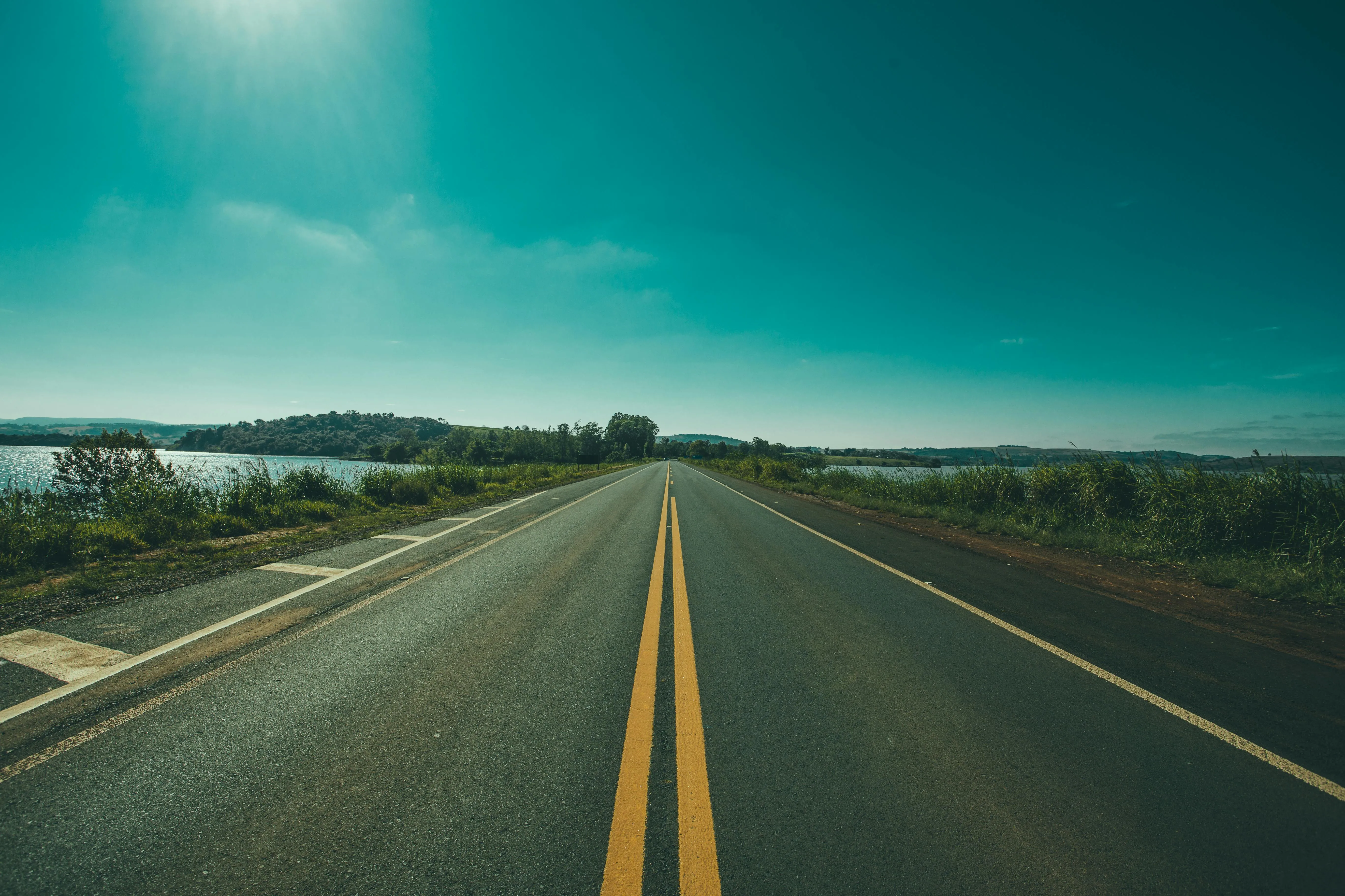 Empty Road Leading Into Distance Beneath Greenish Sky