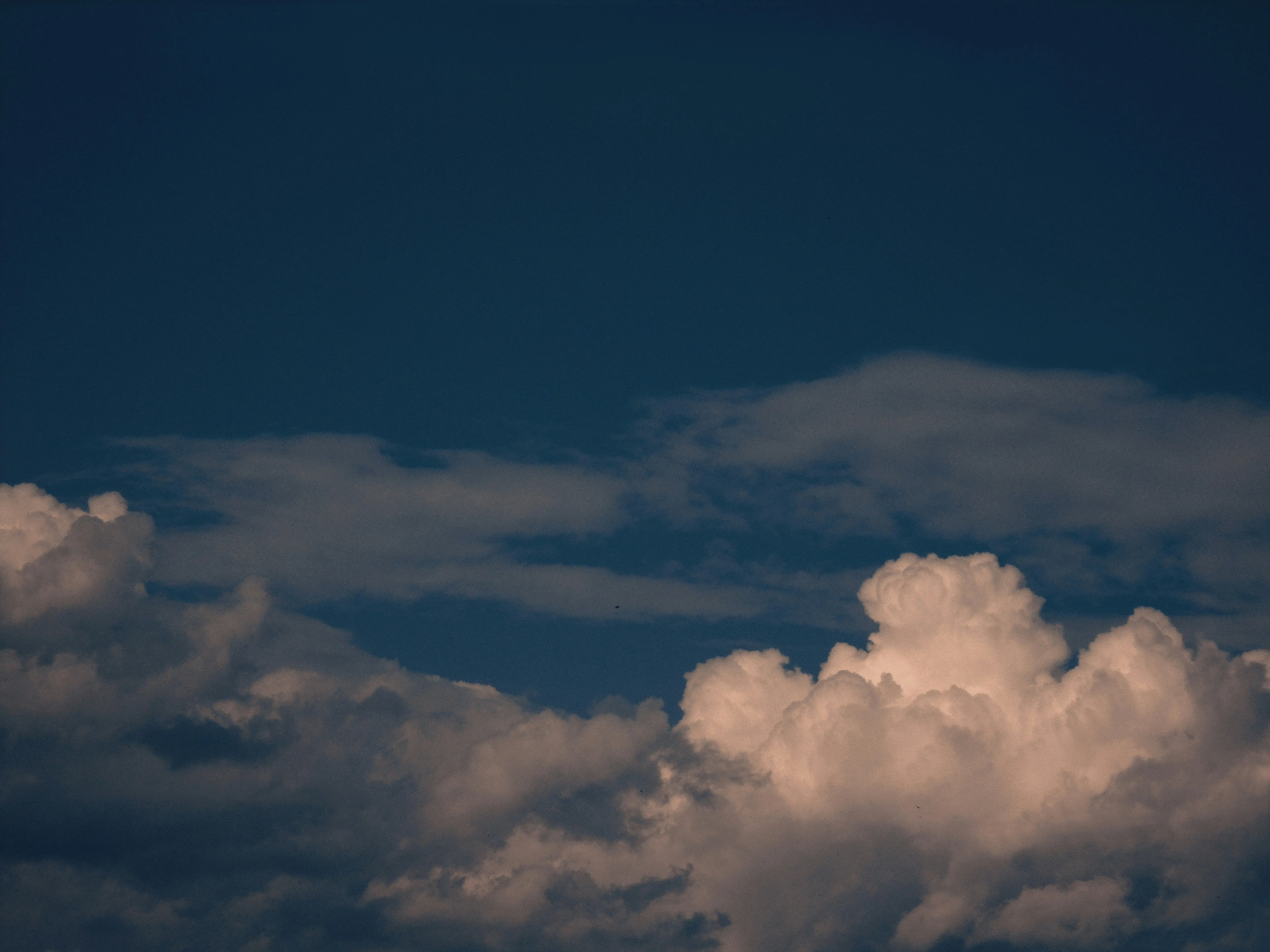Evening Sky with Orange and Blue Clouds Over Horizon